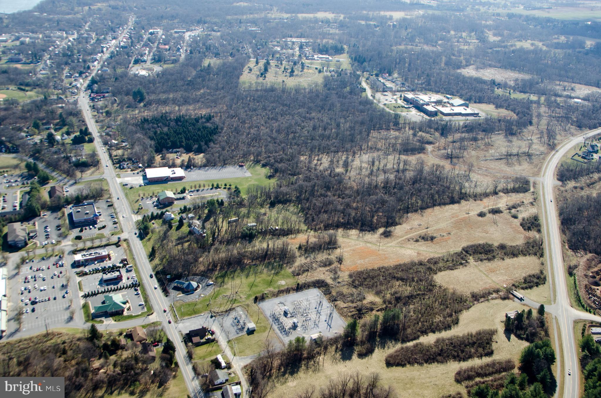 PRIME PROPERTY! 4 adj parcels totaling 23.37 acres, with 386' frontage on Rte 45 across from Maddex Square shopping center and 300' on Potomac Farms Drive. Access points from both. Mostly gentle slopes. 2 existing resid structures + sev outbldgs Probably the last parcel this close to Shepherdstown with multi-use potential + great access on two major roads. Current zoning RG /in town growth area.