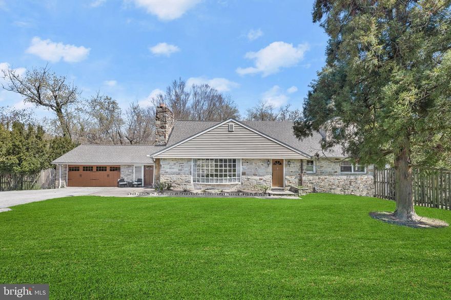 Gorgeous colonial in Catonsville area settled on a little more than three acres of lushly landscaped beautiful hardscaped grounds featuring a stone patio, a pond with a waterfall, and an in-ground pool with an adjacent deck for a truly unforgettable entertainment experience.  Arrive into the main level foyer highlighted by a slate floor that guides you into the open dining and living rooms offering two bay windows, a stone surround wood burning fireplace, stunning homestead wood flooring,  and exposed beams. Enter into the enclosed breezeway with access to the two-car garage that allows for a possible office with a private entrance or a sunroom to enjoy morning coffee, tea, or evening cocktails.  Make your way into the first of two kitchens boasting stainless steel appliances, a breakfast nook, 42” cabinetry, and a Juliet balcony. Relax and unwind in the entry-level primary bedroom suite with two walk-in closets and a ceramic tile walk-in shower. The upper level allows for relaxation with three additional bedrooms, an office, and an updated bath with dual vanity and a walk-in ceramic tile shower to complete the sleeping quarters.  As you make your way to the sophisticated and expansive lower level from the main level, you will pass the dual entry hall bath that allows for tranquil moments with a jetted soaking tub and a dressing table. The lower level awaits with great anticipation and provides a number of possibilities with ceramic tile flooring, a second brick surround wood-burning fireplace with grill, a powder room, a wet bar,  and a sprawling gourmet kitchen to create delectable delights with a sizable center island with a breakfast bar, a Thermador gourmet stove, a sub-zero refrigerator, a decorative backsplash, and granite counters.  Major commuter routes include I-195, I-695, I-95,  and a plethora of outdoor adventures await in Patapsco State Park-Avalon Area, Cascade Falls Trail, and Rolling Road Golf Club, Guinness Brewery not to mention CCBC and UMBC.  Recent Improvements: Central Air Unit-2023, Roof - 2018, New Hall Bath 2017,  Exterior Siding - 2010, and  many more!!