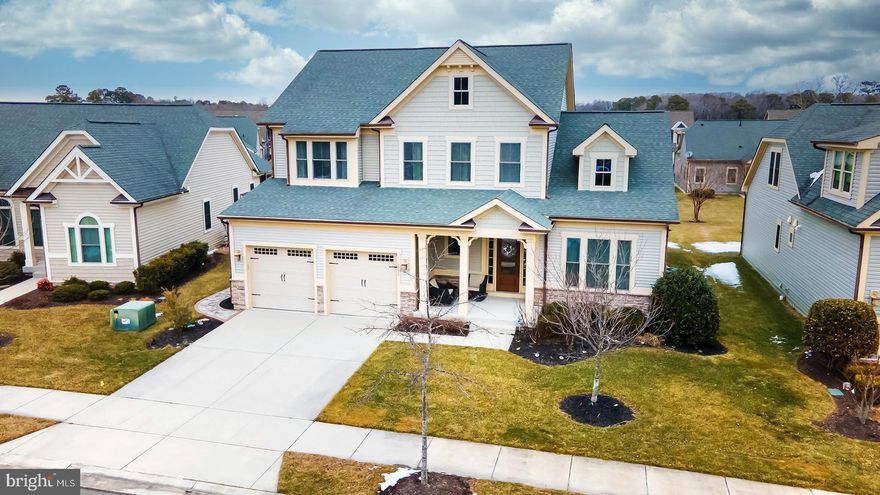 TURNKEY IN BAY FOREST! Welcome to this beautifully furnished 5-bedroom, 4-bath coastal retreat in the highly desirable Bay Forest community, offering over 3,000 square feet of thoughtfully designed living space. Showcasing coastal style architecture with elegant, high-end finishes throughout, this home greets you with a light-filled foyer that flows seamlessly into a dramatic two-story great room featuring a coffered ceiling, a wall of windows, and clerestory windows that bathe the space in natural light. A loft above overlooks the living area, enhancing the home’s open and airy feel. The open-concept floor plan connects the great room to a stunning gourmet kitchen, complete with granite countertops, stainless steel appliances, a cooktop with hood fan, wall oven, built-in microwave, walk-in pantry, and abundant cabinetry accented by a specialty backsplash. A large island with double sinks, pendant lighting, and counter seating for four makes entertaining effortless. Adjacent to the kitchen, the dining room offers direct access to the covered rear porch—perfect for indoor-outdoor living. The main-level owner’s suite is a serene escape, highlighted by a tray ceiling, plush carpeting, and a spacious walk-in closet. The luxurious ensuite bath features double vanities, a window for natural light, a large tiled step-in shower with bench and glass door, and a private water closet. A main-level guest room with full bath, along with a laundry room with utility sink and a functional mud room, complete the first floor. Upstairs, a mezzanine overlooks the great room and leads to three additional bedrooms, two full baths, and a versatile bonus room with glass pocket doors—ideal for a media room, office, or play space. Outside, the landscaped front yard includes a welcoming covered porch and walkway leading to a convenient outdoor shower. The backyard is designed for gathering and relaxation, featuring an expansive hardscaped patio with a stone-encased firepit, sitting wall, and grill enclosure.
Residents of Bay Forest enjoy an amenity-rich lifestyle with a beautiful clubhouse offering entertaining areas, library, dining room, and fitness center. Rentals are permitted with a 7-night minimum, making this a great investment for second homeowner. Outdoor amenities include a resort-style pool with lap lanes and kiddie pool, putting green, playground, tennis, bocce and horseshoe courts, kayak launch marina, and beach shuttle service. Ideally located just minutes from downtown Ocean View and the pristine shores of Bethany Beach, you’ll enjoy easy access to coastal dining, shopping, entertainment, miles of shoreline, boating, and scenic walking trails.