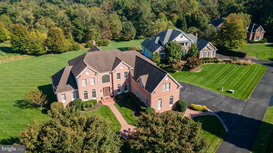 Discover the epitome of elegance in this meticulously crafted 6 bedroom, 6 bathroom home. Nestled in a serine neighborhood on 1.04 acres, this residence boasts 7,000+ total Sq Ft of luxurious living space. A dazzling chandelier and elegant staircase highlight the 2 story foyer that leads to an open concept layout showcasing the family room with a towering ceiling and expansive kitchen with top-of-the line appliances. The first floor boasts of natural sunlight throughout, highlighted by a sprawling in-law suite which includes a bedroom, sitting room, and full bath. Retreat to the master suite, a sanctuary of comfort and style w/sitting room, attached bath, vanity area, and dual walk-in closets. Descend into the expansive allure of a full basement with the inclusion of a bedroom, bar, theatre room and workout room creating the ultimate additional living space. Your meticulously landscaped backyard with deck is perfect for both tranquil moments and lively gatherings. Your dream home awaits!