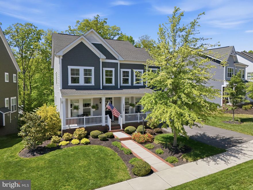 Move-in ready 5-bedroom, 4.5-bath home backing to trees in Potomac Shores with a walkout basement, composite deck, and screened-in porch—offering the perfect blend of privacy, space, and resort-style living in an unbeatable location. This beautifully maintained Brookfield Brighton model features an open-concept floor plan designed for modern living, with wide plank engineered flooring throughout the main level—offering the beauty of hardwood with enhanced durability and resistance to moisture and everyday wear. The spacious kitchen is the heart of the home, complete with a gas cooktop, double wall ovens, and a custom walk-in pantry, opening to the light-filled morning room and inviting family room. Step out from the morning room onto the large composite deck—ideal for entertaining, grilling, or simply enjoying peaceful wooded views. The family room is anchored by a stunning floor-to-ceiling modern fireplace with a sleek linear gas insert and contemporary tile surround, creating a true focal point. Upstairs, the expansive primary suite offers a private retreat with a bright sitting area, two walk-in closets, and a spa-like bathroom featuring a soaking tub and walk-in shower. Three additional generously sized bedrooms include one with a private en-suite bath, along with a full hall bath and a beautifully designed upper-level laundry room. The finished walkout basement adds incredible versatility with a spacious recreation room, full bathroom, and 5th bedroom—perfect for guests, a home office, or multigenerational living. Step outside to the screened-in porch, a peaceful and inviting space that truly extends the home’s living area and allows you to enjoy the outdoors in comfort. Additional highlights include a charming covered front porch, welcoming mudroom, finished two-car garage, a 5-zone in-ground sprinkler system for easy lawn maintenance, and numerous upgrades throughout. Ideally located just down the street from Potomac Shores Middle School, Covington-Harper Elementary, the Ali Krieger Sports Complex, and John Paul the Great High School, with a nearby trailhead providing easy access to miles of scenic wooded trails. Living in Potomac Shores means enjoying a resort-style lifestyle with pools, fitness centers, clubhouse, walking trails, kayak launch, and the Jack Nicklaus Signature Golf Course with Tidewater Grill. HOA includes high-speed internet and trash service, with a future VRE commuter station and town center planned.
This home checks every box—location, layout, upgrades, and lifestyle—all in one of Northern Virginia’s most desirable communities.