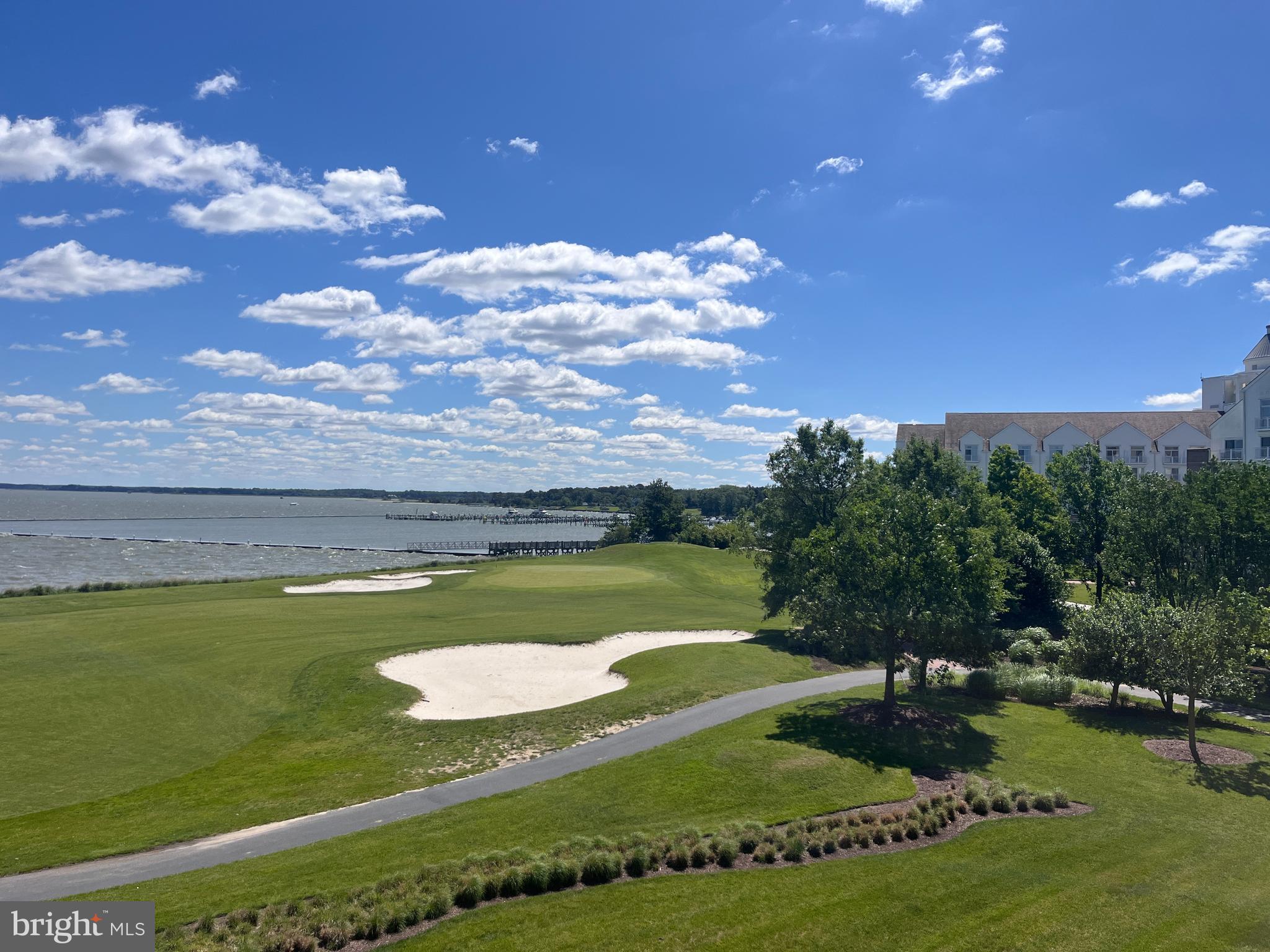 Residences at River Marsh offers carefree living. Enjoy sunrises and sunsets from your private balcony overlooking the 18th fairway and the Choptank River. Your condominium building offers secure entrance to a welcoming lobby and a main level parking garage. On the 2nd floor you'll find #206 tastefully decorated with gleaming hardwood flooring, chair and crown moldings, tray ceilings and stunning views from the living room and bedrooms. Fully equipped kitchen features a new dishwasher, breakfast bar seating, panty and spacious utility room providing additional storage.. New water heater. Primary bedroom has walk-in closet and bath with soaking tup, separate shower and double vanities. Short term rentals are not permitted. Plans for a new club house, pool and tennis courts are in the works. Luxury living is waiting for you!