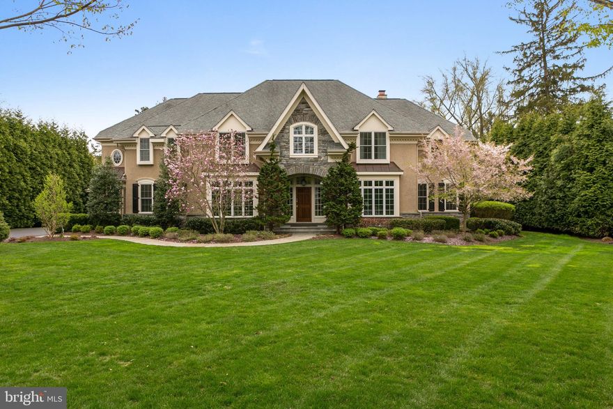 Enjoy life in this Gorgeous Stone Manor home, masterfully crafted to the highest standards designed with comfort and luxury in mind. This expansive residence set on a quiet tree lined street in Radnor has been immaculately maintained. You'll have the best of all worlds here, w private spaces for relaxing and plenty of room for entertaining & hosting holidays. The spectacular grounds that back up to open space are particularly impressive in the rear of the home, with peaceful green views. Lush plantings, perennial flowers and various seating enclaves grace the sprawling property, which can accommodate parties of up to 250. The stately stone facade extends to the exterior of the pool/guest house. Once inside the sunlit home, a dramatic 2-story foyer with grand staircase greets you. The home is finished with beautiful crown moldings, wainscoting, hardwood floors throughout the two stories and sonos wireless surround sound indoors and outside. The open floor plan flows from the gourmet kitchen with seated island equipped with every chef's wish list and opens to the voluminous 2-story family room featuring a wall of windows and stacked stone accent wall w gas fireplace. A sunny breakfast room brings the outside in, leading to a slate patio w built in BBQ, perfect for al fresco dining. A covered portico & pool house with outdoor built-in kitchen is perfect for a cold drink & a bit of shade while lounging by the pool. Back inside, from the family room enter the corner office and playroom/study w custom built-ins and shelving. The spacious dining rm has elegant moldings w butler pantry perfect for entertaining, set alongside the formal living room w powder room. On the 2nd floor your master suite sanctuary awaits with a custom outfitted walk-in closet, and marble spa bath made for indulgence, w Kohler soaking tub and frameless glass shower. Four other spacious bedrooms, with custom closets, one with en-suite bath, provide tranquility for family & guests. A large laundry room completes the 2nd floor. An additional 2,360 sqft finished day-lit lower level w new tile flooring is the perfect hangout w a rec room, exercise area, bedroom and full bathroom/in-law/nanny suite. Featured in Main Line Today, the country French stone carriage house/garage has an upstairs bonus room, outdoor pool house & full bath for sun bathers enjoying the salt water pool. Auto collectors will just love the 5+ car garages with showroom floors, the garages open onto the mudroom with built in benches and extra storage pantry. The grounds are complete w irrigation, landscape lighting, lawn sprinklers, and whole house back-up generator for added comfort. Convenient location, close to top ranked private schools, located in award winning Radnor School District. Close to 476 access, I-76, regional trains, King of Prussia and 30-minutes to Center City, Phila.