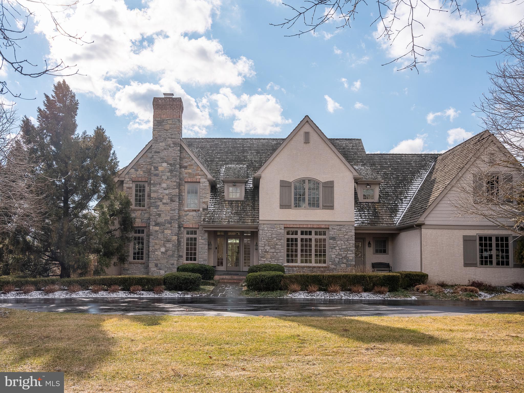 With a well executed design and superior craftsmanship this custom built French Country style home, by premium builder John Arrow, is located on a private cul-de-sac surrounded by Lookaway Golf Club. This spacious home has an inviting front to back entry hall flanked by French doors at either end and flows into the airy living room, flooded with natural light. Handcrafted bookcases, a window seat, and a lovely fireplace make this a wonderful space to entertain. The formal dining room with chair rail and extensive crown molding leads to the butler's pantry with granite counter tops, bar sink, and Sub-Zero wine cooler. The custom designed kitchen with top of the line Premier Cabinetry from Lancaster is a chef's delight, having two Sub-Zero refrigerators, Wolf five burner cooktop, Wolf double ovens, warming drawer, double sinks, and Bosch dishwasher. It is accented with a beautiful mahogany breakfast bar and is open to the family room with tall ceilings and stone fireplace. French doors lead to the outside deck with gorgeous views of the golf course. The handsome cherry paneled office was designed and built by well-known Bucks County Cabinetmaker, William A Draper complete with built in bookcases and file drawers, desk and built-in TV. A doorway leads to a very private screened porch. The first floor of the home is accented with beautiful hardwood flooring and many windows to allow for lots of natural light. In addition, the home has a premium lighting package throughout, a traditional floor plan and good acoustics affording privacy for those working remotely. The second floor has a large primary bedroom suite with vaulted ceiling, sitting area, walk-in closet, and luxurious bath with his/her sinks, stone countertops, tub, shower with body sprays, bidet, and separate water closet. Three additional spacious bedrooms and two baths, one en-suite, and a loft area with crown molding, ideal for another office or studio space, complete the second floor. Two separate staircases access the second floor. The lower level with oversized windows has been finished with a wet bar with Sub-Zero wine cooler, game room, exercise room, sauna, full bath, TV room with surround sound and a cedar closet. Other amenities include central vac, back-up gas generator, sprinkler system for front lawn, and lovely gardens. New smart HVAC system with several zones, indoor fire sprinkler system, and circular driveway.