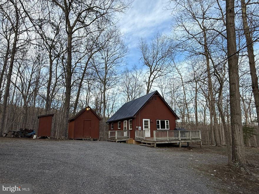 South Potomac Forest located near South Branch of the Potomac River. Tranquil setting in the Rolling Hills/Mountains surrounded by Pines-Softwoods & Towering Hardwoods. Moments away from the River. Home was just had a New Metal Roof installed. New T&G Pine Wood Ceiling installed. New insulation. 
Access to community Fishing Pond within walking distance. Ideal for traveling or commuting to Cumberland MD & or RT 68. Just outside of Springfield & Romney WV. No shortage of Outdoor & River activities. Cozy Cabin & 2 additional out buildings. 2 Bedrooms downstairs with a loft. (chicken coup is not staying) Land lays wonderfully. Peace and quite yet not too far off the beaten path. Vacant. Don't wait. Bring your Offer!