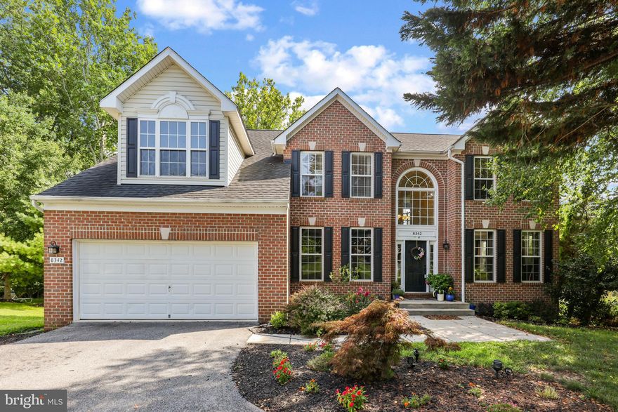 Situated on a cul-de-sac backing to Patapsco State Park in the prominent community of Governors Run, this stately brick front colonial boasting a glittering Palladian window lighting the way into the two-story foyer with a waterfall staircase opening to bright interiors Embodied with luxury and style, this home features enriched hardwoods, beautiful profile crown moldings, a private study accented by wainscoting with a French door entry, a formal living room framed by statuesque columns, beautiful trim and moldings, and heightened windows, followed by a formal dining room showing dentil moldings within the tray ceiling, handsome wainscoting, and a brilliant bay window adding loads of natural light Bask in the rejuvenating sunlight cascading into the family room showing a lighted ceiling fan, three sets of sparkling double windows, and a floor to ceiling stone fireplace with a raised hearth adding to the seating in the room Spark your inner chef in the gourmet kitchen showcasing sleek granite counters, a center island with an elevated breakfast bar, recessed lighting, stainless steel appliances including a canopy hood exhaust system, 42” raised frame wood cabinetry, mosaic backsplash, and an open breakfast room with French door access to the party-sized deck with a state park view Upstairs you find all 5 bedrooms incorporating an owner’s suite presenting an architectural angled ceiling, wainscoting trim, a lighted ceiling fan, a sitting room, 2 walk-in closets, and a luxe bath displaying a double vanity, separate shower, and a jetted tub Unwind in style in the expansive lower level outfitted with a rec room kept cozy by an ambient gas fireplace, a full bath, a media room, a bonus room, and a walkout to the paver patio and backyard entertaining spaces Exterior offers a columned entry porch, a 2-car garage front entry garage, driveway parking, and an elevated low maintenance deck with built-in seating, overlooking the fenced backyard and parklands Highly-desired community is just minutes away from fine dining, shopping, historic Ellicott City, commuter routes, parks, and more!