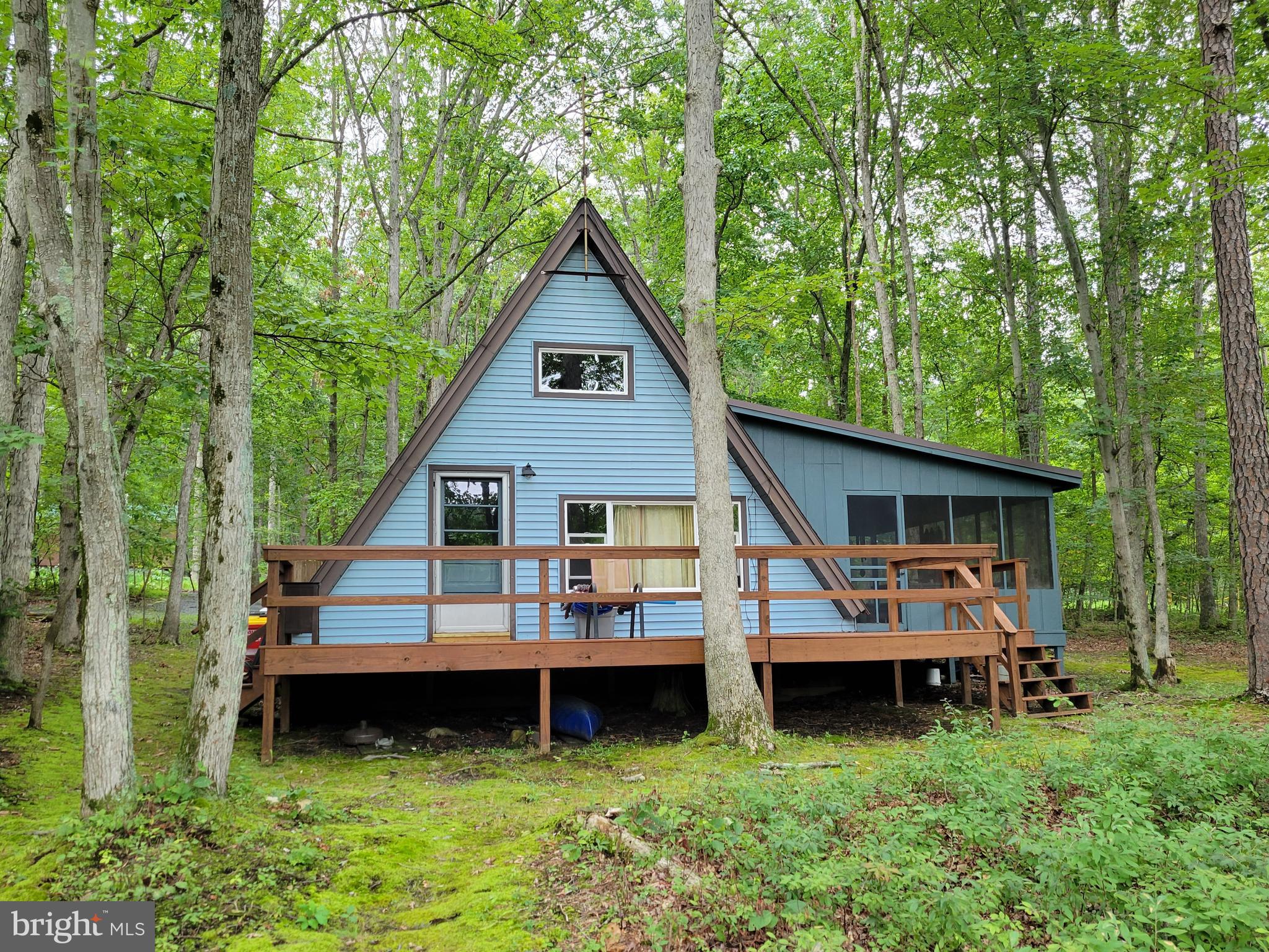 "Lakefront" is a rare opportunity as a permanent residence, part time seasonal home, long term rental or vacation rental. This adorable A frame style home is a mix of modern amenities and 80's charm. Owner has updated and extensively remodeled over the 22 year ownership. From the original 35' continuous exposed beams, knotty pine T&G exposed flooring, to the new modern hand crafted log plank kithchen plus bath to all new LPV flooring. It is sure to pleasure any person looking for wooded Lakefront charm. With a 30' set back line on one side and road frontage boundary, this property can be easily expanded with a room addition or permanent enclosure of the existing framed screened porch.
A detailed list of upgrades and improvements is available on site.
Home is partially furnished with new couch, beds and mattresses.