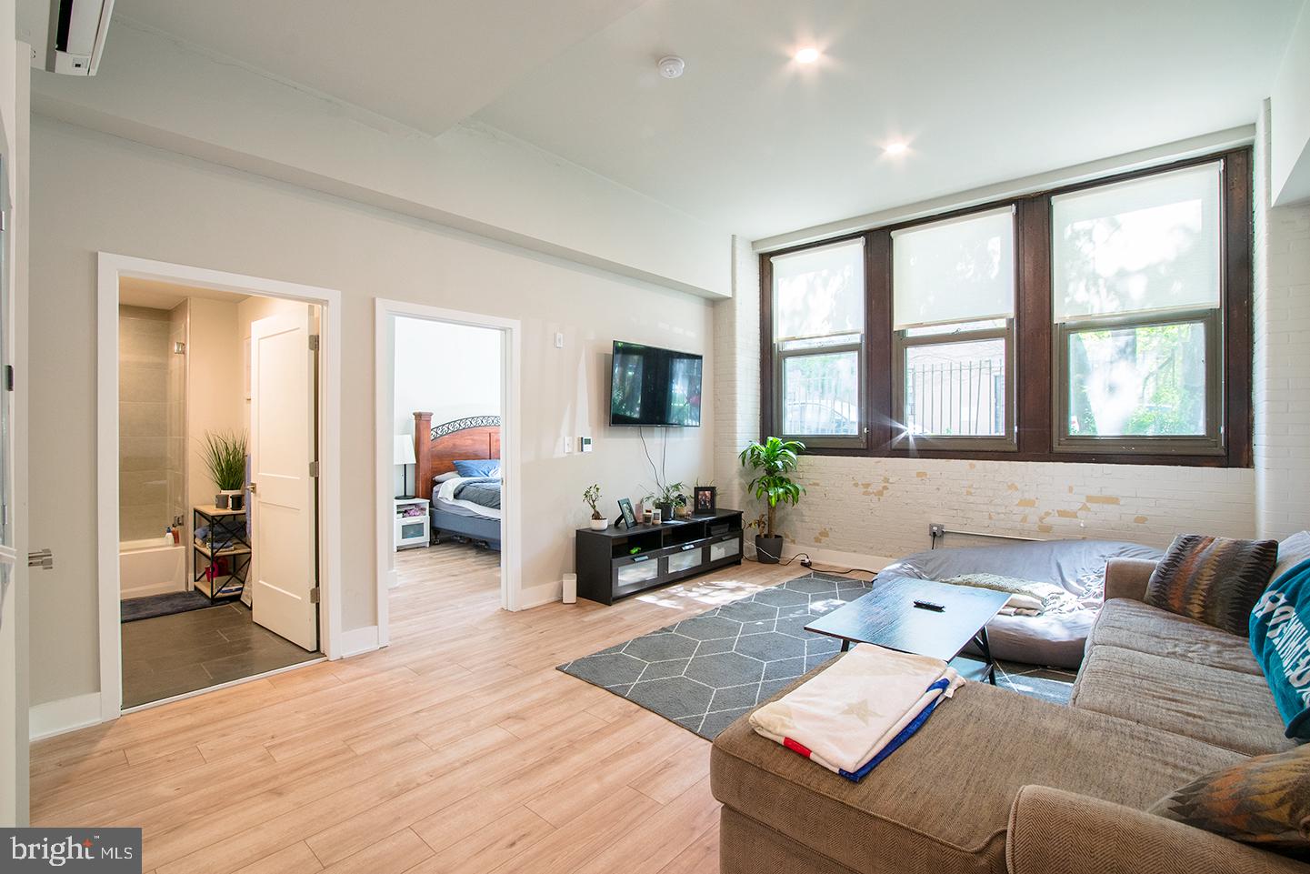 *Available NOW!*

Located in the lower level of the building, this unit has soaring high ceilings with three oversized windows that illuminates the open floor plan living room. The washer/dryer and a deep coat closet are also located in the living room. The bright white kitchen features white subway tile backsplash with white quartz counter tops and a complete stainless steel appliance package. The full bathroom has a modern tiled shower/tub and vanity that matches the kitchen. The bedroom includes a large closet and another large window providing great natural light. You control the cooling and heating with the unit’s mini-split system.

The Walter George Smith Public School, listed on the National Register of Historic Places, has undergone an amazing transformation to bring you these luxury apartments! Each unit features high end finishes while preserving it’s historic character such as the chalkboards, original trim and closets, and overall unique floor plan. All tenants will have access to the two outdoor spaces (over half an acre combined!) on ground floor and mezzanine patios, and roof deck with stellar skyline views! Located at 19th and Wharton in Point Breeze, you’ll be minutes from the OCF Coffee House, American Sardine Bar, Graduate Hospital, East Passyunk and MORE!

*Price reflects the net effective rent after a ONE MONTH credit is applied to a 12 month lease at $1,495/mo.
*Sorry, no cats
*1 dog <45 lbs permitted with owner approval + $50/mo pet fee
*Photos of a similar unit (Unit 9)