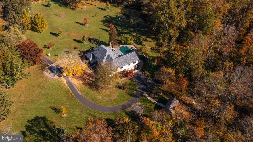 10+ acres, open rolling meadows and woods, a beautiful inground pool and hot tub, a long meandering driveway, and you haven’t even stepped inside…Traditional in its center hall floorplan yet contemporary in style, it encompasses the best of both designs. This home is move in ready with a total house paint and carpet renewal. The special features include a gorgeous gourmet kitchen with artfully designed built ins and a charming wood burning fireplace. The family/great room is spacious, with dimensions enough for billiards, a bar and multiple sitting entertainment areas. Our primary suite is SPECIAL. The wall of windows overlooking this very private property, along with its own deck, dressing area, custom walk-in closet and spa like bath is amazing. Easy to show and our pleasure to sell.