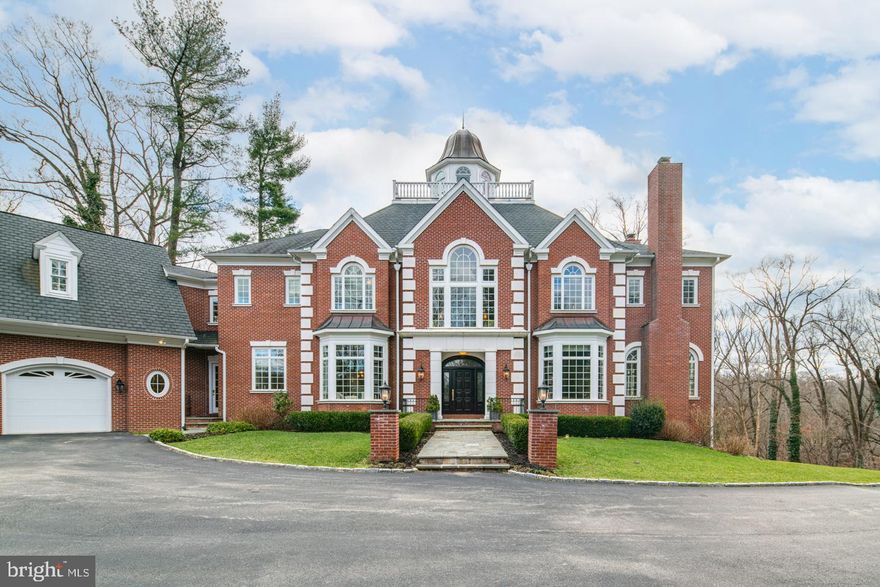 Ideally situated in a serene setting, 67 W Rose Valley Rd is a stately, Georgian style mansion atop a hill in historic Rose Valley, PA. The 3.7-acre estate and its grand entrance is adjacent to 25 acres of the Chadwick and Saul Wildlife Sanctuaries. The over 13,000 sq ft estate was built in 2009 and its every detail was designed by its owner for luxurious and peaceful living. A sweeping deck off the main level overlooks Ridley Creek and connects the kitchen, living room and great room to the outdoors. The lower-level patio connects recreational space to the rolling land. The balcony off the top-level observatory offers panoramic, forested views. Soaring ceilings, large windows and hardwood floors make the home airy and bright. Custom millwork and careful details offer thoughtful elegance. The lower level includes an elegant wooden bar, climate-controlled wine cellar, full refrigerator, microwave, ice maker, gym and sauna. The main floor hosts two offices, a chef's kitchen, formal dining room, living and great rooms, and two powder rooms. A custom staircase leads you to the second floor where you will find the primary suite and 4 additional bedrooms, each with their own full bathroom. The large beautiful primary suite is beaming with a fireplace, two vast walk-in closets and a balcony. The spa-like en-suite has a double vanity, a jet-powered soaking tub, walk-in shower, and two water closets. The bathroom floors are heated throughout and there are two separate laundry rooms. An in-law suite with a full kitchen can be found at the far-east wing of the estate. The third floor hosts a basketball court, rec-room, full bathroom and wet bar with a spiral staircase to an observatory. The estate also has a 4-car garage. Historic landmarks like the Hedgerow Theatre, The Old Mill and the Thunderbird Lodge are all next door. Rose Valley offers history, art, warmth, community, and an award-winning, Blue Ribbon school district. Nearby Media has boutique shopping, bars, and restaurants. Quick access to Rt-1, I-476, I-95, and Septa's Regional Rail means an easy commute to Center City, Philadelphia.