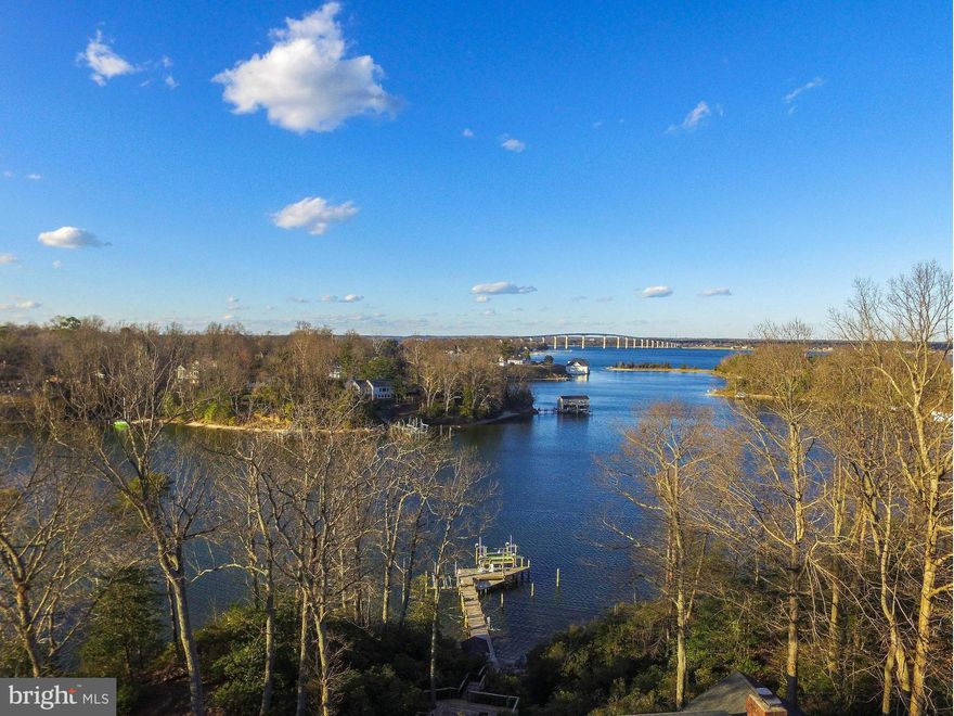 Fabulous waterfront w/views to the Solomon's Bridge; deep sailboat 8-9' MLW, 2 boat lifts, jet ski lift, beachy area! Gorgeous remodeled KT w/all the upgrades, FR w/stone FP wall, sunrm, ofc, main-level MBR. Luxury mbath w/dual vanities, jetted tub, marble shower, Calif Closets install in WIC. 3 decks, firepit, 3-car gar. Refinished hdwd looks gorgeous! Lovely water views from every living space!