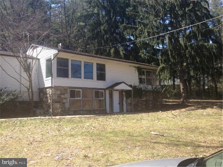 Spacious, open floor plan in this 4 bedroom 2/1 bath raised ranch in desirable Upper Providence on a beautiful wooded lot. First floor welcomes you into the large great room with fireplace. Two nice size bedrooms and full bath. Laundry room and storage area. Second floor consists of bright open living room with stone fireplace and wall of windows. The dining area has a lovely bay window which overlooks the decks and lovely tiled pool. Large country Kitchen with sliders to pool area. Hardwood floors throughout second floor and powder room. Two large corner bedrooms and full bath. Two car garage with inside access to first level. Newer heater, roof, windows and pool rehabbed. 1 year Home Warranty included.