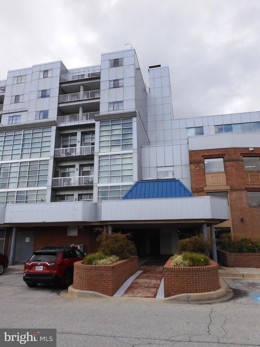 Condo with water view!   This two bedroom two full bath condo has been freshly painted and new carpet installed.   Move in ready!   Primary bedroom has an en-suite bath with a large walk in closet.   Living/Dining area has two sliding doors that let in lots of light and boasts  water view,  marina view and a fabulous city scape.   Step out on the balcony and enjoy!  Open kitchen concept.   Washer and dryer in unit.   One reserved parking space (#254 in Garage door #2 North side of building)  .  Lighthouse Point E. is  a gated community and is centrally located, easy on to Boston St. and 95.   As Is Sale