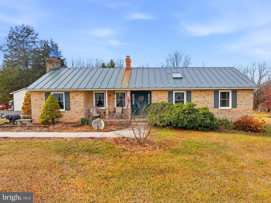 Discover the charm of this beautifully renovated ranch-style home, nestled on a generous 3.88-acre lot that offers a serene retreat from the hustle and bustle. This property will also include an additional 1.49acre lot bringing the total acreage to 5.38. Built in 1985 and thoughtfully updated in 2023, this residence boasts a perfect blend of modern comfort and classic appeal. Step inside to find a warm and inviting interior featuring four spacious bedrooms and three bathrooms. The heart of the home is the family room, seamlessly connected to the kitchen, making it ideal for gatherings. Enjoy the elegance of upgraded countertops and stainless steel appliances in the kitchen, complemented by a formal dining area for special occasions. Natural light floods the space through energy-efficient windows and skylights, enhancing the cozy atmosphere. The fully finished basement provides additional living space, perfect for a home office or entertainment area. A wood-burning fireplace with glass doors adds a touch of warmth and ambiance during cooler months. Outside, the property is a nature lover's dream, backing to lush trees and offering picturesque views of the garden and mountains. The screened porch invites you to relax and enjoy the tranquility of your surroundings. Additional features include a detached garage, a shed for extra storage, and a circular gravel driveway for convenience. This home is not just a place to live; it's a sanctuary where comfort meets nature, ready for you to create lasting memories. Professional photos to come.