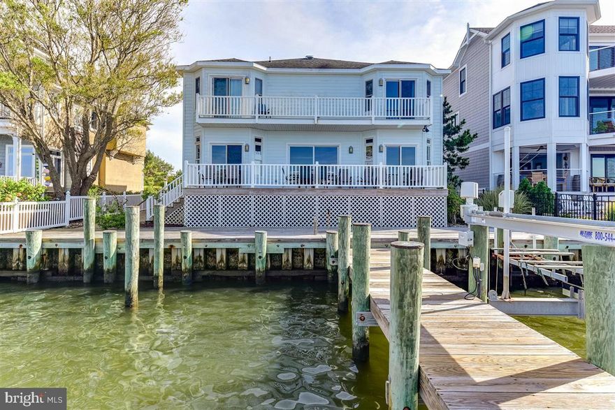 Location!  Location! Location!!!  Stunning DIRECT BAYFRONT living with breathtaking open bay views.  This 6BR/4BA Direct Bayfront single family home is 3343 sq ft.  Homes with unobstructed views of the Bay are rarely available for sale in Heron Harbour Isle.  This beautiful home overlooks the Bay and comes complete with a boat slip with lift, jet ski lift, and an additional single slip right out your back door!!   Share precious family time watching magnificent sunsets from the family room and dining area overlooking the Bay.  You will enjoy your front row seat for the fireworks from Northside Park.  The comfortable dining area is perfect for entertaining family and friends.  The large kitchen has plenty of cabinet space, large countertop and an eat in breakfast area.  There are 2 bedrooms and 2 full baths on the first floor.  On the 2nd floor there are 4 additional bedrooms and 2 full baths.  Two of the bedrooms are Bay facing opening to a deck.  There is a large garage and the driveway affords plenty of parking. This home has brought much joy to the two families that own the home now. They have made priceless memories to last a lifetime.  One of the many highlights of this home is the awesome decks and balconies.  Use them to relax, listen to the water, watch sunsets night after night, and enjoy the boats as they go by.  Imagine yourself in this beautiful home in one of the nicest communities in Ocean City.  Heron Harbour Isle is amenity rich with two outdoor pools, an indoor pool, a kiddie pool, fitness center, social room, sauna, locker room, two Har-Tru tennis courts, sidewalks and piers.  Enjoy your boat, fishing, crabbing, kayaking and paddle boarding all directly out your back door.  The home is being sold fully furnished for your immediate enjoyment.