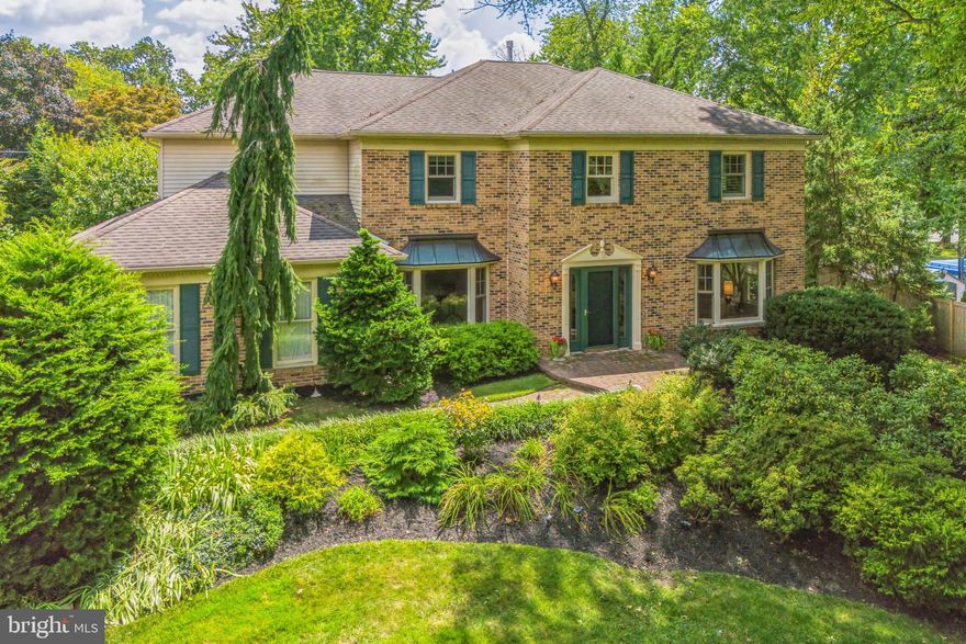 Nestled in a cul-de-sac setting and down a long driveway, sits 720 Buckley Circle in beautiful Lower Gwynedd Township. This updated executive-style brick-front colonial falls within the sought-after Wissahickon School District, which is one of the most highly regarded school districts in Montgomery County. The property is located just a short walk from Lower Gwynedd Elementary, Wissahickon Middle and High School, Pen-Ambler Park, and the Lower Gwynedd Township walking trail system. This house has been meticulously cared for and updated both inside and out. Walk through the front door into this charming home which features beautiful hardwood flooring throughout the first and second floors. The two-story foyer boasts an updated hardwood staircase and railing as well. To your right is the spacious formal living room full of light from two western exposure windows and a large bay window. To the left, the formal dining room with wainscoting and a bay window and French-door leads to the gourmet kitchen. Walk down the center hall passed a roomy powder room and large coat closet towards the rear of the home where you will find an open and bright family room with lots of natural light, a brick hearth with gas fireplace, and custom wood window blinds and a recessed bar area. The family room opens seamlessly to a fantastic kitchen which is custom designed with granite countertops, under-cabinet, and work lighting, a large island workspace with pendant lighting, and plenty of cabinets for storage and display. It is equipped with top-of-the-line  appliances including a gas cooktop with custom hood vent. The laundry room, which is conveniently located off the kitchen by a quaint pocket door, has been redesigned and includes a stainless-steel tub, an Electrolux washer/dryer on a raised platform, and additional storage closets. Access to the large two car garage is also located here. Upstairs you will find four bedrooms and a sizeable center-hall bathroom with updated tile, a new combination tub and shower, and a double vanity. The primary suite includes a spacious bedroom area with a large adjoining sitting room, plantation shutters, a skylight, and two large custom-designed walk-in closets. The master bath includes another skylight, a double vanity, whirlpool spa tub, and separate shower. Three very sizeable additional bedrooms complete the second floor. Professionally landscaped, the property offers privacy throughout the year with specimen trees and perennials. The rear yard features a stunning 25,000-gallon Carlton in-ground, salt-water, heated swimming pool and spa, premium hardwood tongue and groove cedar wood and aluminum fencing. A large deck surrounds the pool for outdoor dining and relaxation, while a custom paver patio above the pool deck provides additional space for patio furniture and comes with a retractable awning. The basement level features two custom-designed play/work areas with built-in bookcases, a large game closet with built in shelving, a separate storage closet, and a large, unfinished workroom equipped with additional built-in storage and a workbench. The basement also houses two sump pumps and a waterproofing system. The property has undergone various upgrades, with all windows, doors, storm/screen doors, and garage doors being replaced. The entire first floor has been recently repainted. The electrical system is surge protected. In the event of an interruption to the public electric utility service, a Generac 22 kW generator with an automatic transfer switch provides whole-house electrical service. It is beyond evident that this home has been cared for and loved by its current owners. Once you walk through the door you will realize you have nothing left to do except drop your bags and call 720 Buckley Circle HOME!