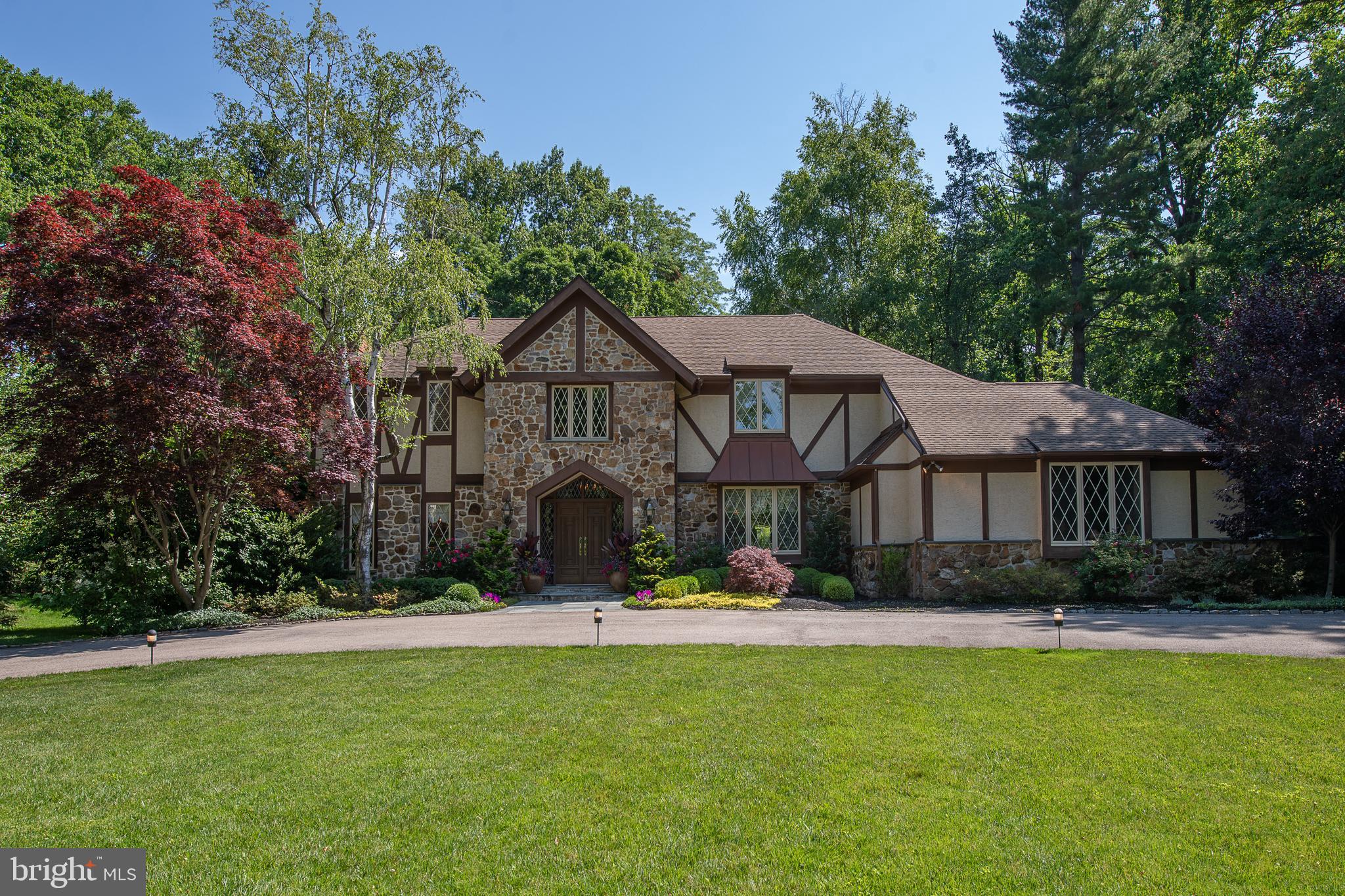 Must see this custom 4+bedroom 3.5 bath home in Bryn Mawr at the end of a picturesque cul-de-sac street with gorgeous private grounds and a beautiful pool. The two story entry hall features a grand curved staircase and opens to an expansive living and dining room both with hardwood flooring. The living room offers a gas fireplace, plenty of light, wood beams and leads outside to a brick patio and lusciously landscaped yard. The dining room is outfitted with beautiful custom built-ins which offer a tremendous amount of storage for all of your serving dishes and glassware. As you wrap around from the living room you ll find a cozy family room with yet an additional gas fireplace and sliding glass doors leading out to the patio as well. Adjacent to the family room is an eat in kitchen with a large center island. Sliding doors out to the second brick patio allow you to soak in the gorgeous views of the landscape and pool as you prepare your meals. The kitchen opens to the dining room as well as the laundry room that leads to a two car attached garage. The main level floor plan is ideal for entertaining! Upstairs, you'll find a lovely master bedroom suite with two grand walk-in closets, a large separate alcove with more closet space and an additional area perfect for a sitting room or office. The master has been connected to an adjoining bedroom which makes up the second walk in closet and fabulous dressing room that was recently redone(very easy to change back to a 5th bedroom). The master bathroom was tastefully renovated with marble. It has a large walk in shower with glass doors, double sinks and a make up area. Two other large bedrooms, hall bath and linen closet complete this level. The finished basement has a seating area, game area (think pool table or pinball) and plenty of storage as well as a bedroom and full bath. This house has a sump pump and French drain and a whole-house generator. It is meticulously maintained and incredibly secluded while enjoying easy access to major roads and highways as well as the sought after Lower Merion Schools.Don t miss this amazing opportunity!