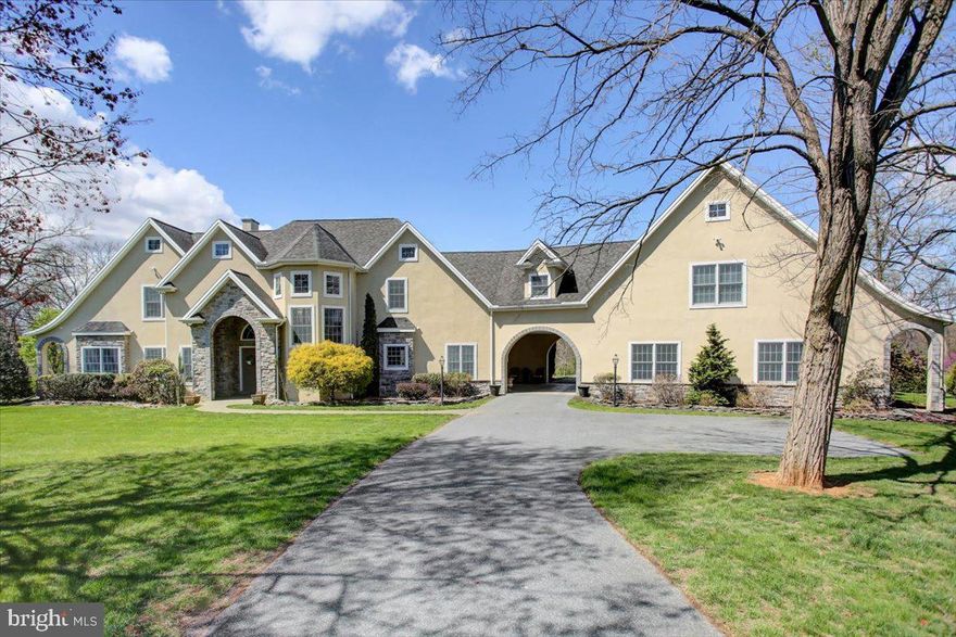 Introducing an exceptional Global Luxury offering — a spectacular Roland custom-built estate boasting over 4,200 square feet of exquisitely finished living space above grade. Perfectly positioned on more than 5 private acres, this home combines grand scale, refined details, and serene natural surroundings to create an unparalleled living experience. Step inside and be welcomed by an abundance of natural light, an open-concept layout, and a dramatic two-story great room anchored by a soaring stone double-sided wood-burning fireplace — the heart of the home.  Ideal for entertaining, the main level showcases beautiful hardwood flooring, crown molding, and recessed lighting throughout. The gourmet chef’s kitchen is a showstopper, featuring gleaming granite countertops, stylish tile backsplash, a massive center island, stainless steel touchscreen smart appliances, including wall-mounted ovens, a microwave, a warming drawer,  and a refrigerator. Offering five spacious bedrooms — with potential for a sixth — and seven baths (5 full, 2 half), the layout includes a luxurious owner’s suite,  with walk-in closets and a spa-like ensuite featuring a walk-in tiled shower, Jacuzzi tub, and dual vanities.  Several other generously sized bedrooms boast private ensuite baths, creating an ideal layout for both everyday living and hosting overnight guests in comfort and style.  A spacious upper-level landing and cozy reading nook add charm and functionality.
Step outdoors to your own private oasis — an entertainer’s dream and a sanctuary of relaxation. The stately porte cochere leads to a heated, oversized three-bay garage, while the backyard unveils a spectacular multi-tiered heated saltwater pool with diving board, a covered mahogany-ceiling patio, built-in granite bar island, hot tub, and fire pit..  Entertain effortlessly with ceiling fans, 3-zone lighting, and integrated audio systems. The lush grounds also offer a small pond, a detached one-car garage perfect for lawn equipment or additional storage, and plenty of space for a garden.  Enjoy a game of tennis or pickleball at your private court.  Wildlife frequently visits this natural retreat, and wooded areas provide tranquility and privacy, enhanced by a tree-lined setback driveway and landscaped front yard. A rare and remarkable opportunity — this estate is truly one of the finest homes to host, relax, and enjoy luxury living in harmony with nature.  Ideally located in York County, Pennsylvania, this property offers the perfect blend of seclusion and accessibility — less than 15 minutes to Ski Roundtop and Gifford Pinchot State Park, and just 20 minutes from the state capital, Harrisburg. For those looking to stretch the day into a weekend getaway or business trip, you're only an hour and a half from Baltimore, two hours to Philadelphia or Washington, DC, and a short three-hour drive to the hustle and bustle of New York City.