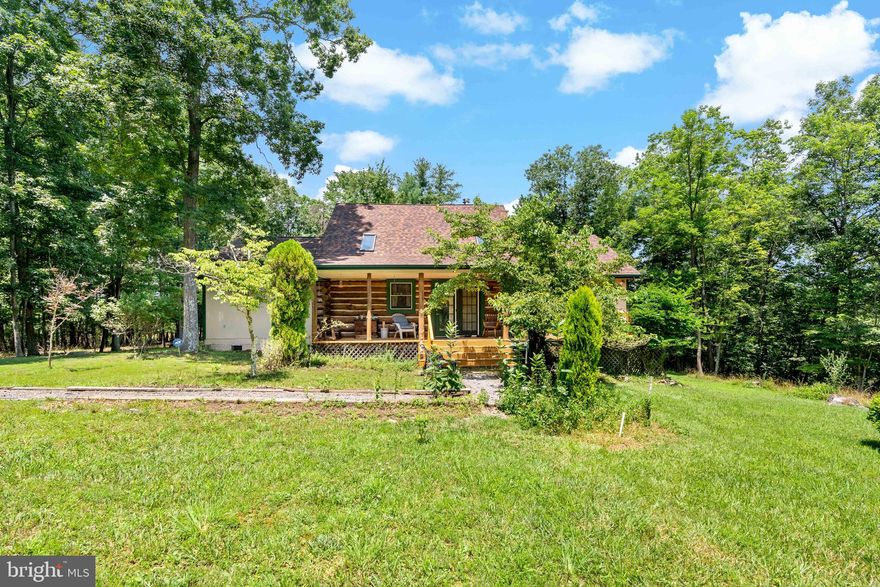 Welcome to wild wonderful West Virginia...Come home to the country.  Step into this lovely log home built with love and built from the logs on this property.   UNRESTRICTED LAND...2 lots = 10.62 acres.  This lovely home has 3 bedrooms with a loft.  2 bedrooms have closets, and one bedroom has an armoire.  The room off the dining area is being used as an office but can be a bedroom.  Nice size bathroom with separate shower and a claw foot tub.  Laundry room is right off the full bath.  Hardwood floors in the Kitchen and living room. Cozy living room with a woodstove and a deck off both sides of the living room.   Nice loft area for an extra bedroom or the art room. This log cabin comes completely furnished. Just bring your clothes, your food, family (if you want) and your weekend will be covered.  This property is very peaceful and private for quiet evenings entertaining in the backyard or just relaxing. Winter Views of 2 mountains, Sleepy Creek Mountain and Cacapon Mt. And remember NO RESTRICTIONS and ALL FURNISHINGS CONVEY.