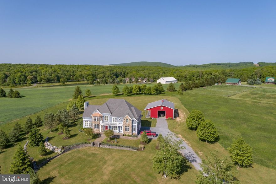 Modern Contemporary Estate near Deep Creek Lake! This elegant 4Bed, 3.5 Bath features vaulted ceilings, open concept living, stacked stone fireplace, and scenic rolling pasture views. Sitting on almost 10 acres, you’ll enjoy Mountain Maryland privacy, with easy access to downtown Oakland, State Parks, Wisp Resort and Deep Creek Lake. It truly is the best of all worlds! Oversized metal barn is perfect for storing everything you need to maintain your acreage, and keep your outdoor toys out of the elements. Ideal for a craft or trade shop as well. Modern gourmet kitchen with massive island and granite tops. Hardwood floors and timber frame accents throughout. Attached three car garage offers plenty of space for all your vehicles. Full unfinished walk-out basement would make for an excellent future recreation/game room, gym or home theatre. Make this gorgeous mountain estate your new home or relaxing vacation retreat. Call today for details!