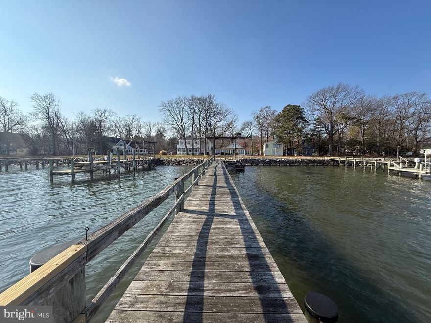 North Beach Waterfront Compound in Holland Point — Rare
A once‑in‑a‑lifetime opportunity in sought‑after Holland Point, North Beach, Maryland: a rare large multi‑lot waterfront compound with an expansive private dock, sunrise-to-sunset views, and extraordinary flexibility for boating, fishing, crabbing, guests, hobbies, or multi‑generational living.

The main waterfront residence welcomes you with an updated kitchen, dining and bath, then opens to lodge‑style living  designed for effortless hosting: multiple bedrooms, each with its own in‑room sink, and a spacious family room positioned closest to the water. Step outside to a lovely enclosed wrap around patio that flows to the oversized dock—perfect whether you’re an avid boater or simply want to watch the sun dance across the Bay from your porch.

Two additional improved properties and several extra lots enhance this offering. One waterfront features large garage and upstairs you’ll find a bright great‑room, full bath, and flexible space for a guest room or an ideal office/studio. There’s also a lot situated behind this property for future possibilities. To the right on the street side sits` another house that includes multiple garage and boat bays—excellent for cars, marine gear, or workshops. Above is a 2 bedroom 1. 5  bath home with large great room and kitchen. Altogether, this is a unique coastal compound with room to spread out, store your toys, and savor Chesapeake living. 🌊🚤