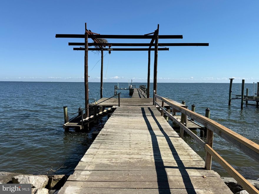North Beach Waterfront Compound in Holland Point — Rare
A once‑in‑a‑lifetime opportunity in sought‑after Holland Point, North Beach, Maryland: a rare large multi‑lot waterfront compound with an expansive private dock, sunrise-to-sunset views, and extraordinary flexibility for boating, fishing, crabbing, guests, hobbies, or multi‑generational living.

The main waterfront residence welcomes you with an updated kitchen, dining and bath, then opens to lodge‑style living  designed for effortless hosting: multiple bedrooms, each with its own in‑room sink, and a spacious family room positioned closest to the water. Step outside to a lovely enclosed wrap around patio that flows to the oversized dock—perfect whether you’re an avid boater or simply want to watch the sun dance across the Bay from your porch.

Two additional improved properties and several extra lots enhance this offering. One waterfront features large garage and upstairs you’ll find a bright great‑room, full bath, and flexible space for a guest room or an ideal office/studio. There’s also a lot situated behind this property for future possibilities. To the right on the street side sits` another house that includes multiple garage and boat bays—excellent for cars, marine gear, or workshops. Above is a 2 bedroom 1. 5  bath home with large great room and kitchen. Altogether, this is a unique coastal compound with room to spread out, store your toys, and savor Chesapeake living. 🌊🚤