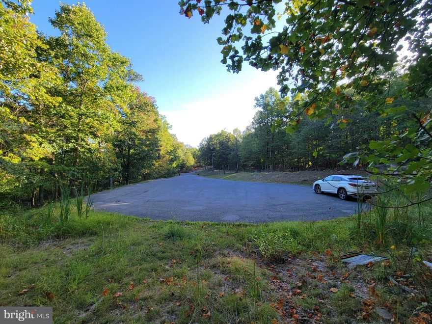 Prime Building Lot in Cacapon East - Lot 51 located on cul-de-sac, lightly wooded building lot, surrounded by nature. Private sewer available for hook-up. HOA covers maintenance of roads. Enjoy Cacapon State Park activities just 3 minutes away. Located about 5 min south of charming Berkeley Springs and 10 min to I-70. This is a choice lot, don't delay.
One-time fee sewer connection fee is $3,950.