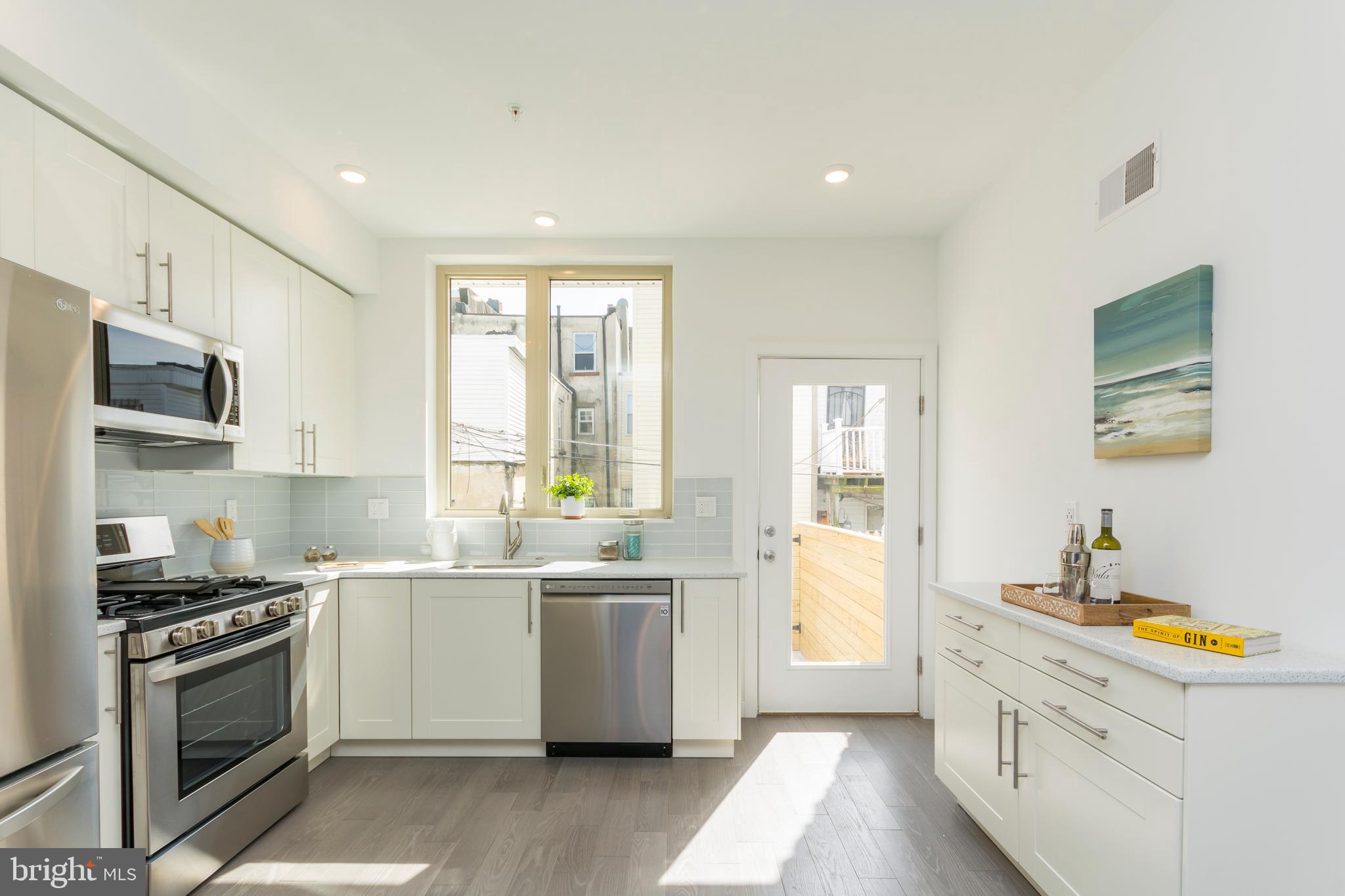 New Construction located in Passyunk Square Neighborhood Assoc with a ten year tax abatement. This beautiful new construction boasts 3/4" wide plank oak flooring throughout and custom wrought iron railings from the basement to pilot house. There is an abundance of LED wafer high hat lighting throughout the home on every floor, including the basement and much natural daylighting. Front entrance is equipped with The Ring doorbell and leads to living room/dining room area. The kitchen has under counter lighting, an LG appliance package with french door refrigerator, convection oven, large microwave that vents to the outside, garbage disposal and white quartz countertops with work space. Rear yard is nicely sized for additional outdoor space. The Basement is fully tiled with hardwood looking planks, has full three piece bathroom with walk-in shower, laundry room and a high ceiling. Second Floor has two bedrooms large closets and frosted glass doors to allow natural light in hallway, tiled bath with lighted mirror and tub. Third Floor is the Master bedroom and ensuite on the entire floor with phenomenal views of the city a walk-in closet and plenty of storage. The ensuite feels spa like and has a walk-in shower . Upward to the rooftop you will find a large pilot house and spectacular 360 degree views of the City where you can watch the fireworks from any direction and enjoy the LED illuminated view of the city from your own skybox. Two HVAC units. Broker is related to seller.