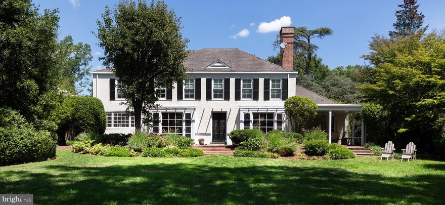 8316 Navajo Street - A coveted location - wonderfully secluded yet in the center of all things Chestnut Hill. Travel down the charming cul de sac with community garden to this exquisite 4 bedroom, 4 bathroom home. The welcoming entry hall opens to the expansive walls of picture windows, drenching the home in natural light and showcasing views of the over-sized, landscaped yard, originally designed by renowned landscape architect, Fred Peck. The gracious living room is ideal for entertaining with floor to ceiling windows, custom built-ins, a wood burning fireplace and access to the garden.  The adjoining elegant dining room with its own wall of windows leads into the updated eat-in kitchen. This custom designed kitchen has just the right combination of functionality and style, as featured in Better Homes and Gardens Kitchen and Bath Ideas. Quartz countertops, Sub-Zero, Miele & Bosch appliances, custom banquette, and ample cabinetry. A comfortable family room with a gas fireplace features views out to the covered slate patio. With its neighboring full bathroom, the family room functions as a multi-use space for office or guest quarters. A beautiful curved staircase leads to the second level. The grand master suite boasts a luxe dressing area / walk-in closet and en suite bath with dual vanity, all resplendent with natural light. Three additional sizable bedrooms, one with en suite bath and walk-in closet, an additional Jack & Jill bath, excellent closet space and full laundry room complete this level. The oversized, attached two-car garage provides convenience and protection from the elements as well as considerable built-in storage. A short walk to Pastorius Park, SEPTA Chestnut Hill West line, Wissahickon Valley Park, and all the Chestnut Hill shops and restaurants.