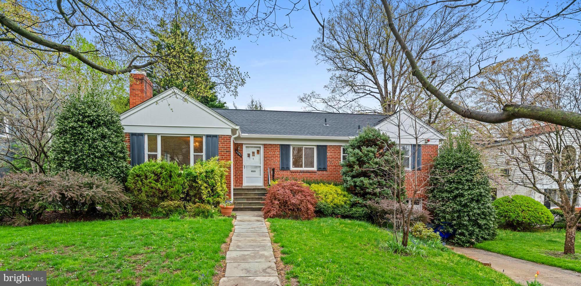 Warm, wonderful home on a beautiful street in the desirable Sumner / Mass Ave Hills neighborhood of Bethesda. This immaculate, light-filled, and freshly painted ranch features three bedrooms / two full baths on the main level, including the primary bedroom with an en suite full bathroom.
The welcoming first floor boasts gleaming hardwood floors, crown moldings, a gracious and sun-drenched living room with built-ins and a handsome fireplace, as well as an adjoining formal dining room also with oversized windows and chair rail molding. The functional kitchen sports calming, neutral tones, ample counter space, a breakfast bar, as well as a range and built-in microwave. There is a purposeful door to the lovely back patio and private yard, perfect for dining and relaxing al fresco and entertaining small or large gatherings.
Downstairs, the recreation room with wood-paneled walls also enjoys exterior access, and there is an additional fourth bedroom, another full bath, laundry, and storage. Other offerings include a huge unfinished attic for even more storage and an attached one-car garage for private, off-street parking.
5607 Namakagan Road creates a wonderful opportunity to live on a charming street with neighborhood parks, a library, a bus stop, shops and restaurants of Westbard Square, and the Capital Crescent Trail nearby. Also convenient to downtown Bethesda, Friendship Heights, Spring Valley (D.C.), the Metro, and major commuter routes. Wood Acres, Pyle, Whitman serve the neighborhood.