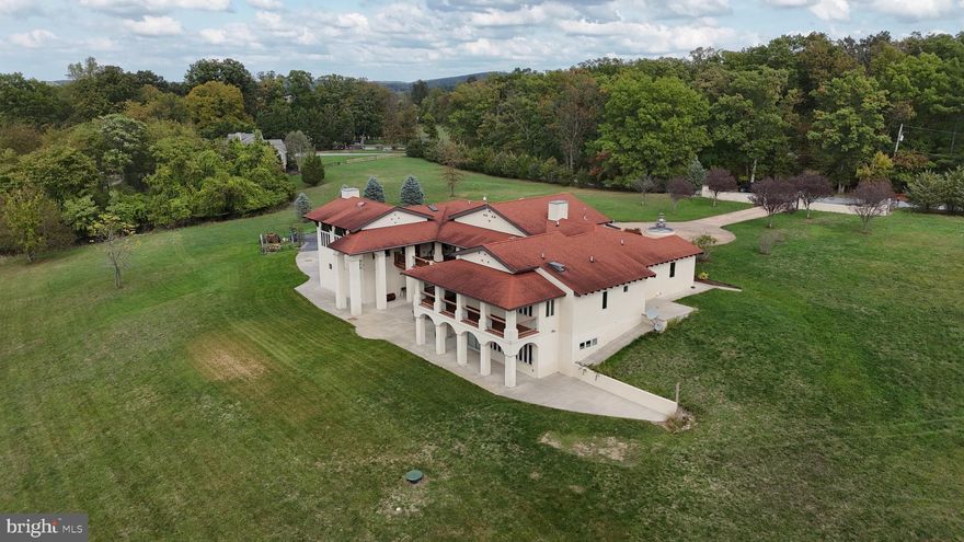 Welcome to this stunning custom Mediterranean-style Villa nestled on 15 acres with the most picturesque views. With 5 bedrooms, 3.5 baths,  and over 8,400 sq. ft. of living space, this home offers the perfect blend of luxury and tranquility. 

As you step inside, you'll be greeted by the grandeur of the high ceilings, arched doorways, and an abundance of windows that fill the home with natural light. The first floor boasts an open floor plan with a spacious living room, dining room, gourmet eat-in kitchen, butler's pantry, family room, and three bedrooms, including a massive primary bedroom with a full bath. The wrap-around deck off the living room provides the perfect space to entertain, barbecue, and enjoy the company of friends and family while overlooking the breathtaking view of the pond and mountains.

The above-ground basement level is a complete second home, offering a full custom kitchen, separate living and dining room, three additional rooms that can be used as bedrooms, a 2nd laundry room, and a theater room. This space is perfect for multi-generational living, a guest suite, or as an income-producing unit.

Step outside and discover the beauty of the 15-acre property. The circular driveway leads to a courtyard with a charming fountain. The rear patio is an idyllic spot to gather with loved ones and enjoy the peaceful surroundings. The property also features a pond and agricultural land and is zoned to have up to 4 horses or to be used as a winery, wedding venue and so much more. Zoned AG and MLS attachment shows all the uses for this unique home.

This home offers the best of both worlds - privacy and convenience. With easy access to local amenities, schools, and major highways, you'll have everything you need just moments away.  Don't miss the opportunity to own this one-of-a-kind dream home!
**Sellers need a short HOC contingency.  A 24-hour notice is required.***
