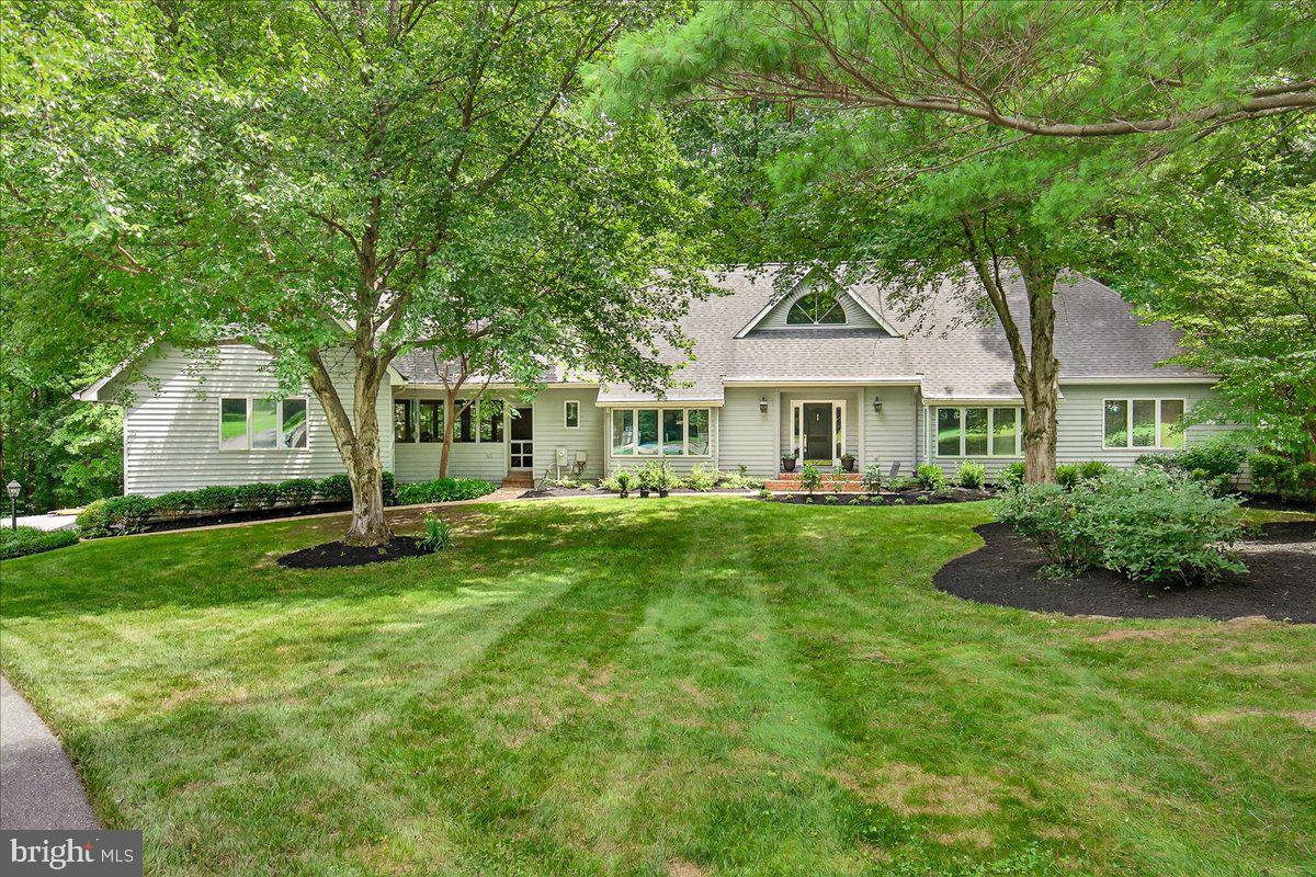 Welcome to this custom home retreat on over three acres of private woodlands and walking paths at the end of a quiet cul-de-sac. This one-of-a-kind home combines modern design and the tranquility of nature and Update thought out.
Step inside to find Instagram-worthy windows framing the surrounding woods, vaulted ceilings, and a floor-to-ceiling stone fireplace. French doors on either side of the fireplace open to the screened-in outdoor living space in the treetops- the perfect spot for enjoying morning coffee, listening to bird song, and finding quiet moments with nature.
The upgraded eat-in kitchen features abundant storage, lots of granite counter space, pull-out shelves, a large center island with pendent lighting, and a box window above the sink with views of the forest below. The formal dining room, currently used as a library, offers additional space for entertaining or relaxing. Just off the kitchen is a laundry room/ mudroom and a second screened-in porch with its own swing bench- the perfect place to enjoy evening breezes. This porch leads to an oversized three-car epoxy coated garage with extra high ceilings offering lots of room to store kayaks, bikes and more.
The main-level primary suite has a custom walk-in closet, oversized tub, and serene views from multiple windows. A nearby office provides a work-from-home setup with wooded views. An additional bedroom and full bath on the main level add flexibility for a guest room, multigenerational living, a second office.
Upstairs, a catwalk-style hallway overlooks the main floor and leads to two large bedrooms and a full bath. The finished, walkout lower level adds even more living space with a second family room with a woodburning fireplace, huge picture windows, and dual French doors leading to a covered patio beside bushes of edible berries. You’ll also find a fourth full bath, a large bedroom with an adjacent dressing room or office, an exercise room, and multiple storage areas—one finished and one with roughed-in plumbing for a potential fifth bath.
The property includes expansive front lawns and several acres of mature woodland with walking paths, a zipline, a bench nestled among the trees, and a huge stone-rimmed firepit ready for roasting marshmallows and visiting with friends and family.
Additional highlights include: three zoned HVAC systems, new HVAC, custom kitchen built-ins, upgraded appliances, premium doors and windows including new windows, and no HOA. This home offers comfort, privacy, and the beauty of nature. Schedule your private showing today.