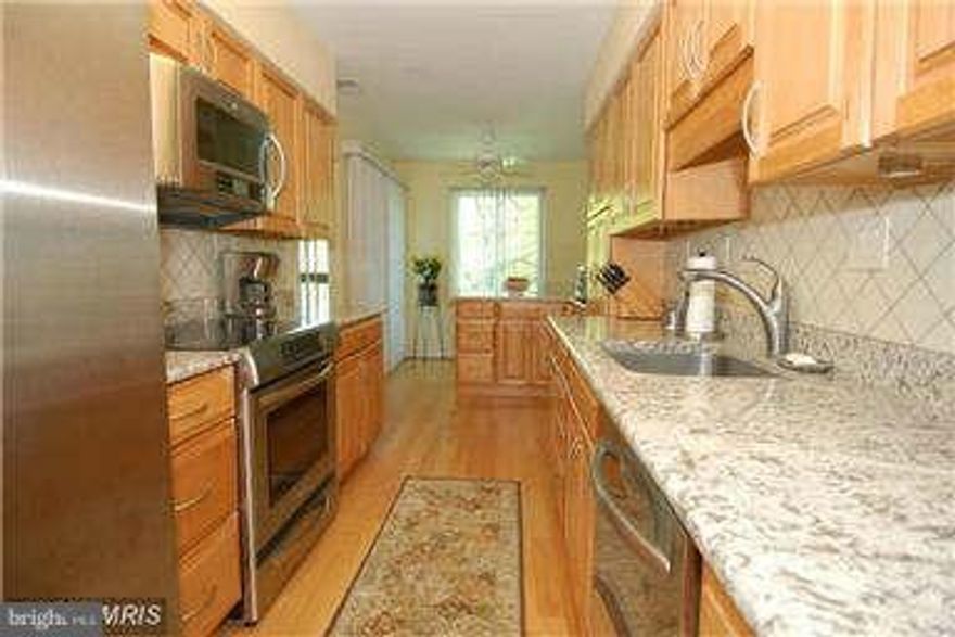 TOP floor w/ 1 Garage Parking plus Plenty of Parking in designated Treebrooke parking lot for 2nd car.   1,347 sq ft of living space!    Gorgeous Kitchen w/quality Cabinetry, Stainless Steel Appliances & Beautiful Granite.   Newer Windows & Sliding Glass Doors to Balcony, Custom Blinds & Built-In Closet organizer in the primary bedroom  Walk-In Closet (See Floor Plan in Photos). 
Large Balcony overlooking Park.  Secure building and Extra Storage.   Located in the Treebrooke community which has a Pool for residents only and a fitness room.     Vienna/Fairfax GMU metro is just 1.2 mi., bus stop across street.  Available for move-in on March 10th.   Don't miss this opportunity to rent this lovely condo!  *Apply Online *$65 application fee per adult