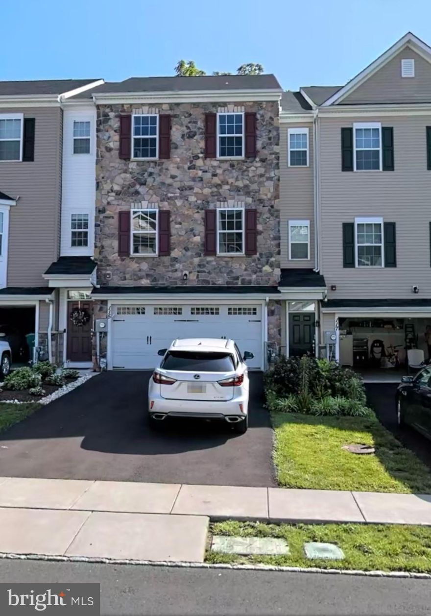 This beautiful stone front townhouse in Somerton Valley is the perfect blend of elegance and functionality. The home boasts upgraded hardwood floor throughout!The open floor plan seamlessly connects the kitchen and dining area, offering island seating and plenty of counter space. The kitchen is equipped with a french door refrigerator and the latest technology auto release dishwasher. Powder room also located on this level. On the 2nd level, the 2nd and 3rd bedrooms share a spacious hall bath complete with linen closet. The 3rd level is home to the primary bedroom, which offers 2 closets, an en suite with walk- in shower, double sinks, bathtub and private toilet. Garage enters conveniently into the finished lower level. The whole house is equipped with smart thermostat so you can control the temperature of each room right through the app! There is a playground and picnic area just a short 5 minute walk away. This tucked away community is still quick access to the Turnpike and I-95. Don't forget to add 115 Master Ave to you list of homes to view today!