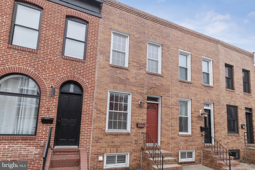 Blending charm and modernity, this remarkable gem located in the desirable Federal Hill historic district boasts two bedrooms, sun-filled windows, and accent brick walls. One of the highlights of the property is its two-tiered rooftop deck, providing a perfect space for outdoor relaxation or entertaining guests while enjoying panoramic city views. The main level features an open concept layout with beautiful bamboo flooring. The living room seamlessly transitions into the dining area that is adorned with custom reclaimed wood shelving, creating a welcoming and spacious atmosphere. Prepare your favorite meals in the updated kitchen equipped with granite countertops, a decorative backsplash, a breakfast bar, stainless steel appliances with gas cooking, refinished cabinets with new hardware, sliding shelves, and lighting underneath. Adjacent to the kitchen is a sunroom that can serve as a breakfast room, additional lounge space, or a home office with a skylight and sliding glass doors that lead to the rear patio. Moving upstairs, you will find the primary bedroom with sliding glass doors that open onto the two-tiered rooftop deck. Down the hall is the second bedroom and a full bathroom with new lighting and faucets, floating shelves, a dual sink vanity and tile tub shower. The lower level offers ample storage space with shelving and a laundry area. Excellent location with close proximity to a variety of dining, shopping, and entertainment options. Riverside Park is nearby, offering a pleasant outdoor space for recreational activities. Being in Federal Hill, you will have access to the best that Baltimore has to offer. Additionally, this home provides convenient access to major routes such as 95 and Hanover Street, making commuting and traveling more accessible. Recent upgrades include new heating and cooling systems with a Nest thermostat in 2021 with a transferable warranty, a new water heater 2021, decks were cleaned, stained and sealed in 2021 as well with lighting on spiral staircase and a dimmer transformer for LED lighting on the deck railing.