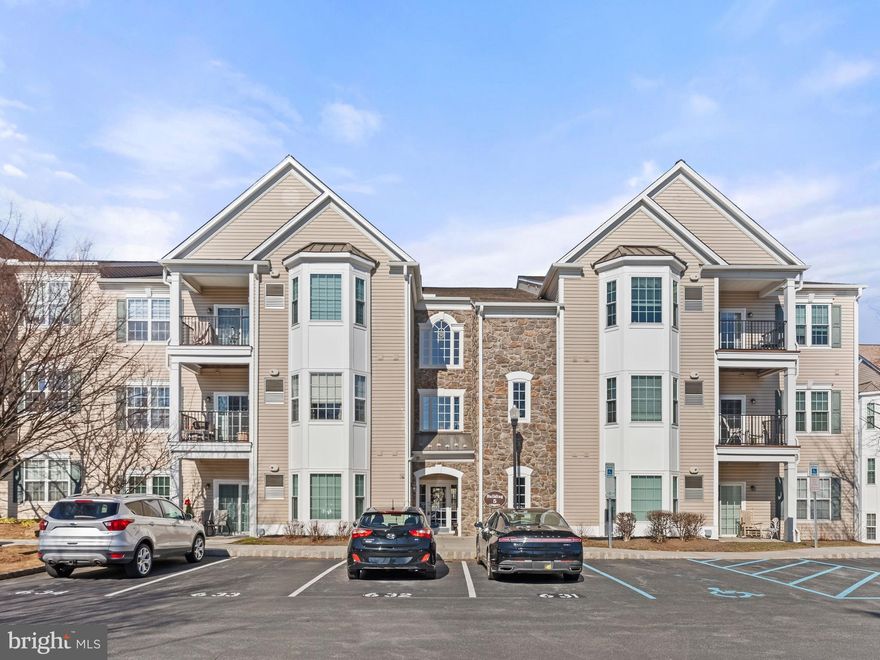 Welcome to this charming 2-bedroom, 2-bathroom condo in the highly desirable 55+ community of Traditions at Ridley Creek! This second-floor flat offers an open floor plan with beautiful hardwood floors throughout the living and dining areas. Upon entering, you'll be greeted by a spacious dining area featuring crown molding and a chair rail, perfect for entertaining. The inviting family room includes a ceiling fan and sliders that open to your private balcony, offering a peaceful outdoor retreat. The large kitchen is complete with plenty of cabinet space, ideal for all your cooking needs.

The master suite includes a ceiling fan, an en-suite full bath with a walk-in shower, and generous closet space. Bedroom 2, also with a ceiling fan, and the carpeted bonus room provide additional living space—ideal for a home office, guest quarters, or whatever suits your needs. Another full bath is conveniently located in the hallway.

The washer and dryer are located off the entrance for added convenience. This condo is just steps away from the clubhouse, giving you easy access to all the wonderful amenities and social activities that Traditions at Ridley Creek offers, fostering a strong sense of community with your neighbors. A one-year home warranty is included for added peace of mind.

This beautiful condo in Traditions at Ridley Creek won’t last long in this highly sought-after 55+ community, so schedule your showing today!