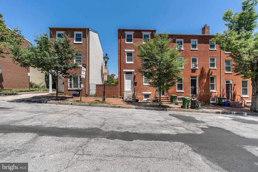 Huge four level end of group home in hot Hollins Place!  This home is move in ready with four finished levels making it ideal for roommates or a smart buy for the savvy investor looking to add to their rental portfolio.  Home features three bedrooms 2.5 baths and finished basement which could easily be converted to fourth bedroom.  Second floor master offers en-suite full bath and fourth floor bedroom offers private balcony.  This home is close to it all!  Steps from GMBC, UMMC, Camden Yards, the light rail, inner harbor and more!   Easy street parking but massive rear patio could easily be converted in to parking pad with room for entertaining to spare.  You don't have to sacrifice a thing on your list with this home!  Contact Meighan Sweeney for your private showing 410.279.0087 MeighanMoves@gmail.com