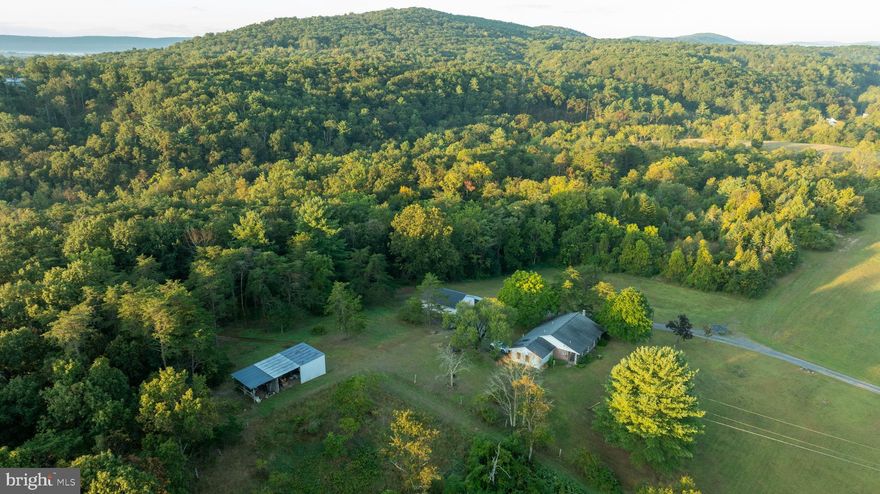 **All Offers to be submitted by 6PM on Friday, September 19th, 2025***
Set on 16.83 acres along Mahanoy Valley Road in Perry County, this property offers a balance of residential comfort and natural land features in a quiet rural setting. Located in the Newport School District, it's truly a  space for outdoor living with quick access to local amenities all while maintaining privacy.

The property includes a single-story ranch-style home with 3 bedrooms and 1.5 bathrooms. Situated above the front yard and pasture, the home overlooks open ground with broad views of the surrounding countryside and mountain hillsides of the State Game Lands across the street. A detached garage provides space for parking or a workshop, and a separate equipment barn offers storage for tools, implements, or recreational vehicles.

The land features a mix of open pasture and wooded areas, offering multiple potential uses. Portions of old pasture fencing remain and could be repaired or replaced to support livestock or hobby farming. Trails weave through the woods, leading to a spring-fed pond and continuing down toward Losh Run, which flows along the property’s boundary. This combination of pond and creek frontage adds to the property’s habitat diversity and scenic appeal.

The area is known for producing large whitetail deer, and the property offers hunting opportunities supported by its wooded cover, open travel corridors, and water sources. The internal trail system makes it possible to reach much of the acreage on foot, horse or by ATV, providing access for hunting, hiking, or simply enjoying time outdoors.

Despite its private setting, the property is close to nearby towns. Newport is approximately 6 miles North, offering schools, shopping, and services. Duncannon is about 7 miles southeast, providing additional amenities and commuter access and Harrisburg is only a 20 minute drive!

Envision your young family playing and enjoying the outdoors, growing up in the creek and the pond. Campfires and hosting of family and friends, taking in the views and making memories. Properties like this don't come up often and certainly not at a price like this! 

Oil, gas, and mineral rights will convey with the sale. The property is served by existing utilities and has year-round access from Mahanoy Valley Road with a shared driveway.