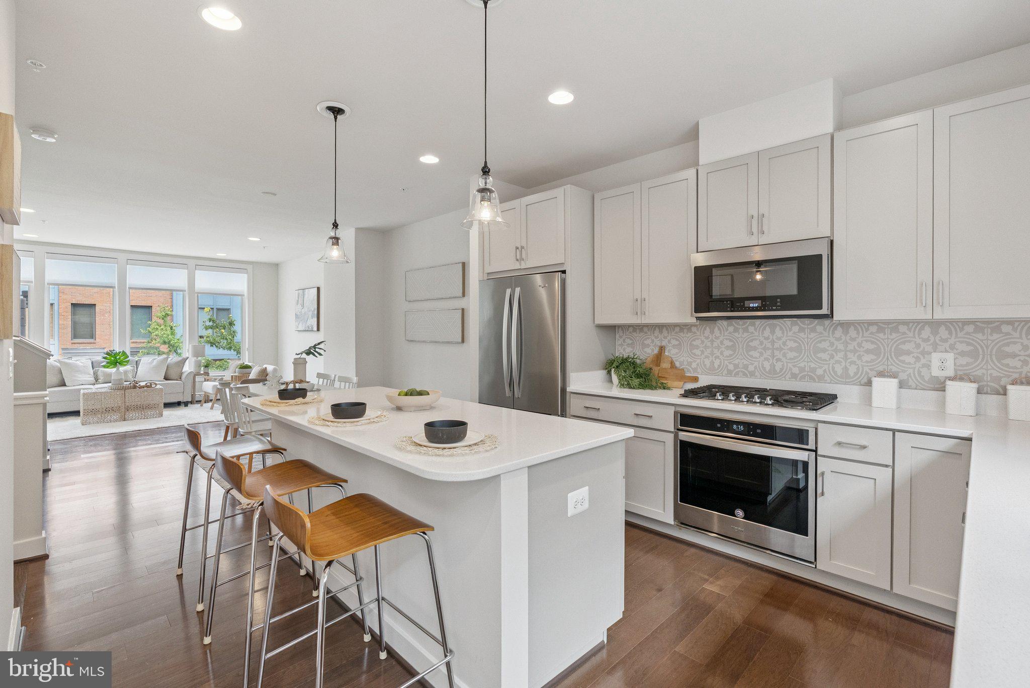 Conveniently situated at the Red Line entrance, this light-filled, LEED-certified Copeland model built by EYA Homes in 2018 blends modern living with ultimate convenience and is move-in ready. This beautifully maintained residence features an open floor plan with hardwood floors, an upgraded kitchen with gas cooking and an island, Energy Star stainless steel appliances, extra large casement windows, a fourth-level loft for additional living space, and an elevated ceiling in the garage. Upon entry, you are greeted with a home office/flex room with a custom decorative mural and access to your two-car garage. The main level takes center stage, featuring a chef-inspired kitchen perfect for showcasing your culinary talents or unwinding in the living room, complete with soaring 9-ft ceilings and an abundance of natural light. The third floor serves as your private retreat, designed for ultimate comfort and relaxation. The spacious primary bedroom features a stylish shiplap accent wall, plenty of room for a king-size bed and nightstands, a walk-in closet, and a luxurious en-suite bath with dual vanities and an oversized shower with a bench. This level also includes a second bedroom with its own en-suite bath, along with a convenient laundry room, adding both practicality and comfort to your daily routine. Finally, the fourth floor offers a versatile loft for extra living space, a third bedroom with its own en-suite, and a private rooftop retreat—perfect for relaxing and enjoying peaceful evenings under the stars. Westside at Shady Grove offers an exceptional blend of urban and suburban living. Enjoy easy access to Starbucks, local shopping, and dining options like the nearby beer and wine store, CVS, and a short stroll to the Metro for quick access to concerts, games, etc. Community amenities include a clubhouse with an outdoor pool, lounge areas, a fitness center, two dog parks, walking paths connecting to nearby trails, and multiple green spaces. The HOA takes care of lawn maintenance and snow removal. Perfectly located just two miles from I-270, four miles from Crown Farm, 14 miles from downtown Bethesda, and 26 miles from DCA, this home offers the best of both worlds: urban convenience and suburban tranquility.