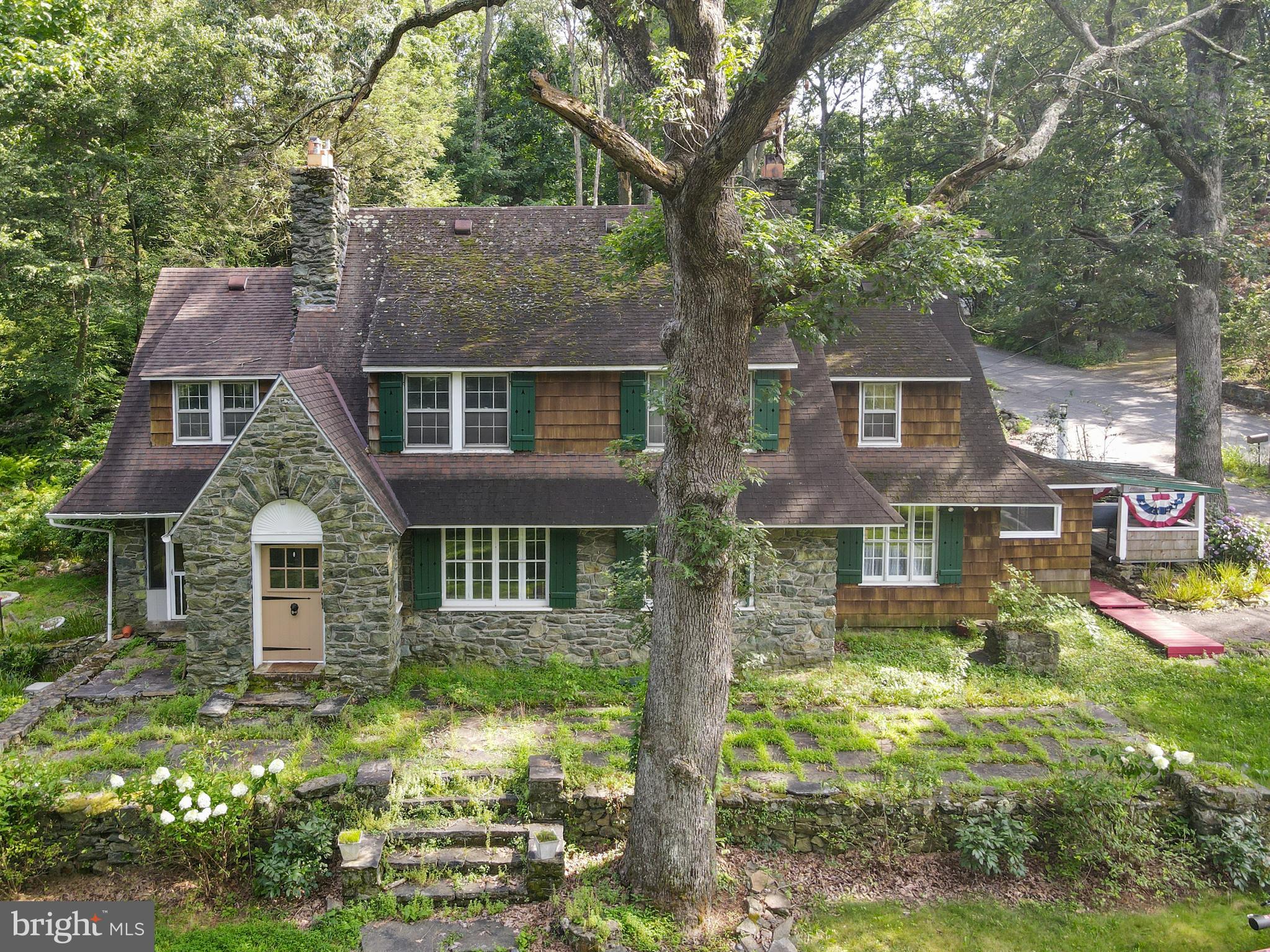 Welcome to this distinctive 3-bedroom, 2 full bath, 2 half bath stone Cape Cod nestled on a picturesque lot surrounded by lush gardens and nature. Boasting timeless character and modern comforts, this home features hardwood flooring throughout and four cozy propane fireplaces, adding warmth and charm in every season. The main level offers a spacious living room , a formal dining room perfect for entertaining, and a kitchen with a large walk-in pantry. A separate mudroom and a screened-in porch add functionality and comfort to everyday living. Upstairs, the expansive primary bedroom is a true retreat—complete with a sitting/changing room and an attached half bath. One of the bedrooms features its own fireplace and private sitting balcony, ideal for enjoying peaceful mornings. Step out onto the large deck from the hallway to fully immerse yourself in the tranquil surroundings and manicured gardens. Additional highlights include a dedicated office room, a walk-up attic offering easy and abundant storage, and a spacious basement for even more storage potential. Upgrades include a new electrical panel (2024), new 50-gallon water heater, new plumbing, and new oil tank. This one-of-a-kind home blends classic Cape Cod elegance with thoughtfully designed spaces—inside and out. A rare find you won’t want to miss! Schedule your showing today!