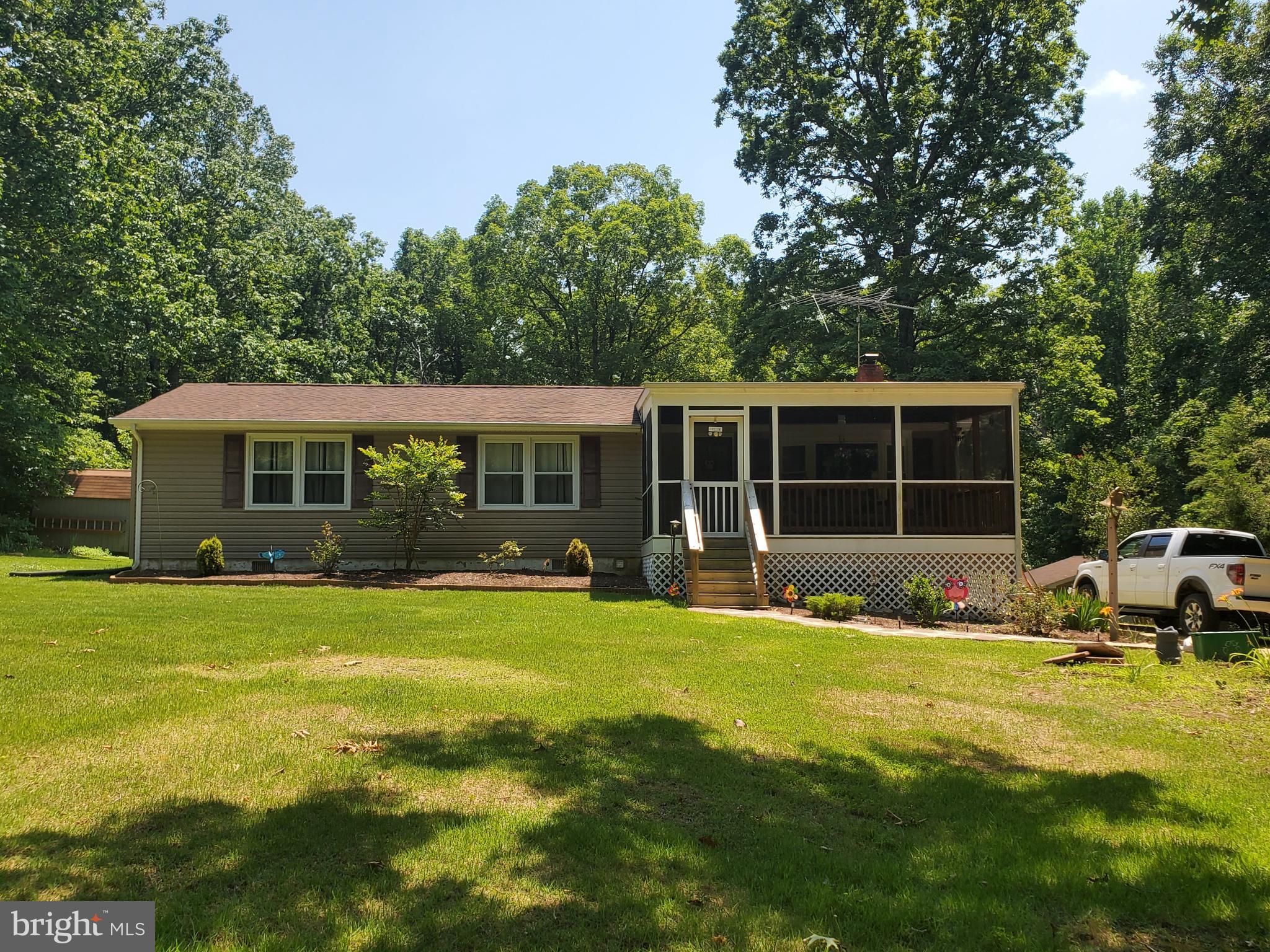This beautifully RENOVATED, 3 bedroom/2 bathroom, Rambler is snuggled on a Ten Acre Nature Lover's Paradise! Home is all new or like new. Its decorated with taste and loaded with luxury: A Kitchen with Stainless Steele Appliances and space for Dining, a Family Room with a Wood Stove, New Pergo Flooring, Bathrooms with New Vanities, Large Bedrooms with Lots of Closet Space, Screened in FRONT and BACK Porch, Plus a 2 Car Detached Garage, 2 Sheds, and a Red Barn! Bring your Horses. Plant your Garden. Have that farm you've always wanted!