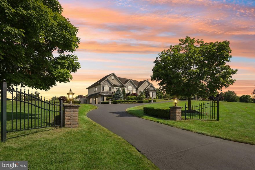 Rarely does a home of this caliber come along. Situated on almost two rolling acres with a rear view of Worcester Golf Club and a front view that goes on for miles - and always will thanks to Evansburg State Park Grounds. The sunsets from the front terrace are gorgeous and unmatched in the area. This distinctive  custom built ranch/rambler home allows for many living options. The main floor is 2480 square feet of luxury and comfort which includes a sunroom, huge kitchen with an entire wall of windows, spacious living/family room, primary bedroom with a luxurious ensuite and laundry area. The matching footprint lower level is also 2480 square feet and has its own separate entrance, three bedrooms, and a large living area that could be utilized as a game room, second family room, or workout area. The versatility of this space makes it conducive to almost any living arrangement your lifestyle requires. For the garage enthusiast, this oversized space is over 12' tall, has an epoxy floor, sink, built-in cabinetry and inside access.  Since purchasing this home in 2015 almost every square inch inside and out has been improved, upgraded and enhanced to create a home of sophistication and convenience. Some enhancements of this distinctive home include hardwood hand-scraped floors on the main level, outdoor entertaining area with 36" grill, sink and fridge adjoining the personal pond and waterfall, Thermador and Bosch stainless appliances, heated floor in main bath and walk thru shower with 7 jet sprays, 3 new high-efficiency heating and cooling systems, abundant hardscaping and lush landscaping, redone stucco and new garage doors, plus handsome metal accent roof. Ask for the extensive list of improvements and plan to come see this meticulously maintained home at one of our 4 open houses.  Don't settle for ordinary when you can have the exceptional!