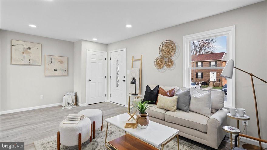 Welcome home to this stunning 4-bedroom, 2-bath townhome in the desirable Woodsdale Manor community. Thoughtfully updated from top to bottom, this home offers modern style, comfort, and functionality.

Step inside to find luxury vinyl plank flooring throughout the main level, leading you into a bright and open living space. The updated kitchen features quartz countertops, stainless steel appliances, a breakfast bar with pendant lighting, and plenty of cabinet space — perfect for both everyday living and entertaining. The adjoining dining area opens through sliding doors to a brand-new deck, ideal for outdoor gatherings.

Upstairs, you’ll find three spacious bedrooms, each with plush carpeting and ceiling fans, plus an updated full bath showcasing dual sinks and contemporary finishes.

The finished lower level offers even more flexibility with a fourth bedroom and attached full bath, making it perfect for guests, a home office, or a private retreat. There’s also a large laundry and storage area with a washer and dryer and plenty of dry storage space.

This move-in ready home combines modern updates with a convenient layout in a prime location — close to shopping, dining, and commuter routes. Don’t miss your chance to make this beautifully renovated townhome your own!