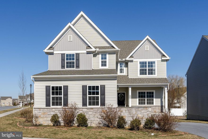 Welcome to 586 Stockdale Dr. This Keystone Custom Homes–built residence features a well-balanced layout in the desirable Worthington community in Manheim Township.

A welcoming front porch leads into the home, where the entry opens directly into a bright and well-appointed main level. To the right, a large light-filled space offers flexibility as a formal living room or a functional playroom. An open staircase leads to the second level as you move into the heart of the home.

The main living area unfolds with an open-concept kitchen, dining, and living room designed for both everyday living and entertaining. The living room is filled with natural light and anchored by a gas fireplace, creating a warm focal point. Just off the living area is a versatile main-level bedroom with a walk-in closet, easily transitioning into a home office if desired.

The kitchen features granite countertops, stainless steel appliances, and a center island that houses a deep basin sink, garbage disposal, and dishwasher while providing extended seating. Additional appliances include a gas range and built-in microwave, along with a walk-in pantry for added storage. The adjacent dining area, open to both the kitchen and living room, includes sliding glass doors that lead to the Trex deck, creating a seamless connection to outdoor living. A small mudroom, coat closet, and powder room are conveniently located as you enter the oversized garage. The home also offers additional expansion potential with a full lower level ready for future finishing.

The second level features four bedrooms and two full bathrooms, highlighted by a well-appointed primary suite. The primary suite features two walk-in closets and an en-suite bath with a soaking tub, stall shower, double vanity, and a private water closet. Three additional bedrooms are well proportioned and complemented by generous closet space, including walk-in and double-door closets. A second full bathroom is conveniently positioned for these bedrooms. The laundry room is generously sized and thoughtfully arranged, offering space for garment care.

Positioned on a corner lot adjacent to the neighborhood’s open common space, the home enjoys easy access to an area where residents gather and play. A full unfinished basement with plumbing rough-ins and an egress window spans the footprint of the home, offering excellent potential to add the additional living space you need. Recently refreshed with interior paint and complete new flooring throughout the home, this property presents a truly turnkey opportunity for its next owner.