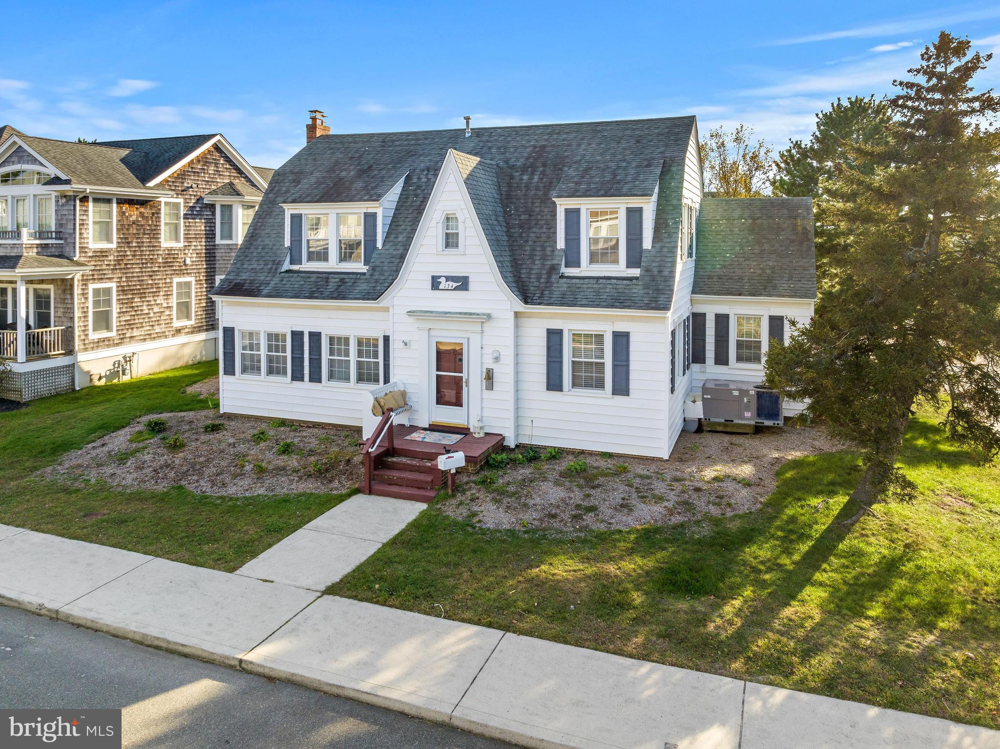 Historical Gem in the desirable LEHYC section! Built in 1929 on an oversize lot on the corner of Belvoir and Beach avenues, this home has maintained its timeless elegance through the years. The current owner took great pride in giving a fresh look to this historic home. New furniture throughout all living, dining and bedrooms along with new light fixtures and fans Her eye for detail blends the charm of this vintage home with elegant decor.
The front yard has been cleared making the front porch an open greeting space. The backyard offers an oasis with a large yard, dining area and lounge area by the in ground pool. a deck complete with awnings, two outside showers and two storage areas offer generous entertainment space.
The foyer contains much of the original framework and floors. The first living space has a fireplace with cable access above. A side porch overlooking the front yard is perfect for a sitting area, office or playroom. A second side room could be another office, sitting space or exercise area. An ensuite with updated full bath is off this living area. The large kitchen has custom cabinetry, granite and tile backsplash. The kitchen connects to a dining room that comfortably seats 8. The second living space connects to the kitchen and allows access to the backyard. Another full bath, laundry area and room for storage completes this floor.
The second floor has been completely redesigned with coastal furnishings. The primary bedroom overlooks the backyard and has a large king bed and a full bath with charming accents. The second bedroom connects to the third, the first holding two queen beds and the second allowing for two twin. The other two bedrooms on this floor overlook the front yard and each fit queen beds comfortably.
Updates have been done throughout and this home is ready for you to enjoy Summer 2024!