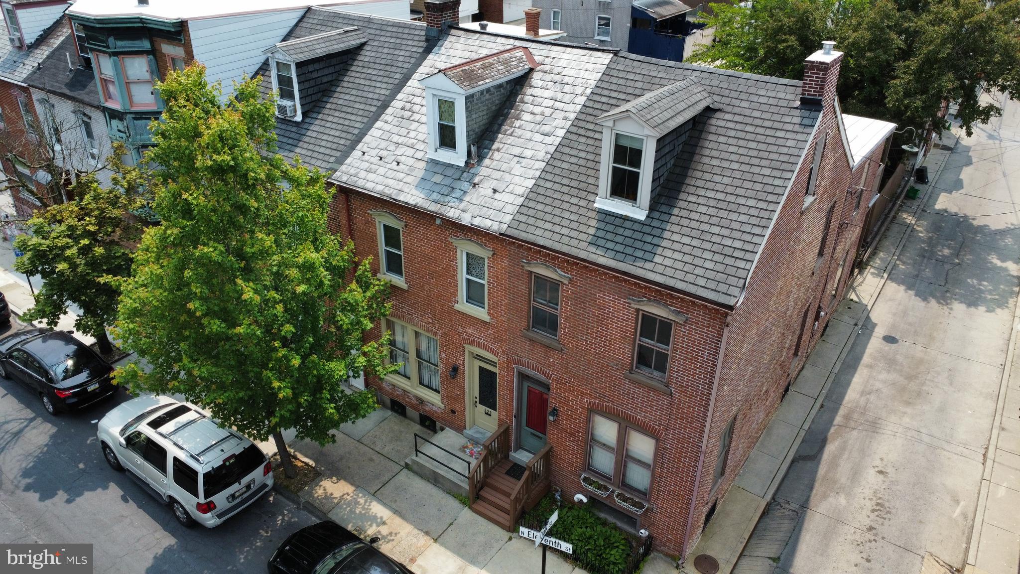 Solid brick end unit on the corner of 11th and Oak in Allentown's Old Historic District. Warm wood floors greet you plus 10 foot ceilings on the 1st floor. Ample light streams through the living room, dining room and kitchen. Wood trim, built in bookcases/shelves and a flexible floor plan. The eat in kitchen has gas cooking, center island with sink, plenty of cabinets and counter space. 1st floor laundry, 1/2 bath and den/office area that leads to the fenced yard and deck. Newer carpeting on the 2nd and 3rd floors. Two additional full bathrooms, access to the rear covered balcony. The 3rd floor is contains a newly finished bedroom with exposed wood beams and vaulted ceilings. Efficient wall mounted Lochinvar gas boiler installed in '20. Convenient location with easy access to shops, restaurants, entertainment and parks. Seller wishes to convey the property in as-is condition. The City Inspection Report is available.