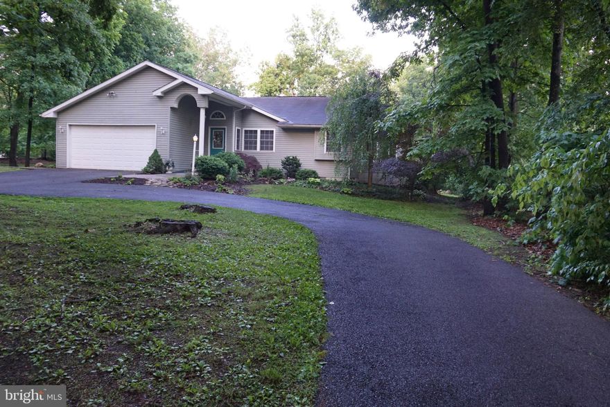 Lovely, custom built rancher with a contemporary flair. The home is nestled in a partially wooded 1.06 acre lot.  Large level back yard, circular drive, landscaping, and shed enhance the outdoor space. Enjoy all nature has to offer on the large open deck or gather in the even larger covered screen porch.  Venture inside to this open and airy living space.  You will feel right at home with large living and dining rooms, well appointed kitchen with lots of storage and counter space including breakfast bar to seat all your friends or family.  There is a breakfast nook that has French doors leading to the screened porch.  The Master Suite is large and relaxing, a perfect respite from your hectic days.  You will feel on vacation any time you need a break by slipping into the hot tub in your private all-season room adjoining the master's suite.  This split floor plan rancher has two additional bedrooms on the opposite side of the home with guest bathroom convenient between them. The owner has made many upgrades throughout, you will appreciate the custom master shower, newer refrigerator, upgraded low-maintenance flooring... speaking of.. the heat is hydronic-radiant flooring.  Winters will be comfy and cozy with warmth under your feet.  Central A/C, Water Softener already installed.  Enjoy a beautiful spring in your new home!  Conveniently located for the commuter to Route 11, I81 and Route 51 in South Berkeley County.