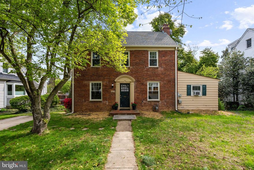 Wonderful opportunity to bring your vision to this quintessential brick Colonial, just blocks from Downtown Bethesda, in the heart of the highly sought-after Battery Park. Full of character and ready for its next chapter, this beloved home offers the perfect canvas to make it truly your own while enjoying the very best of urban suburban living.
Perfectly positioned on a landscaped 7,570 square foot level lot, the home is surrounded by mature trees and plantings, creating a peaceful retreat just a short stroll from Downtown Bethesda. Enjoy unmatched convenience with coffee shops, parks, acclaimed restaurants, and the Metro all just moments from your front door.
Guests are welcomed by warm curb appeal and charmed upon entry. The classic center hall foyer opens to a gracious living room featuring a painted brick fireplace with dental molding, as well as a light-filled, elegant dining room. The windowed kitchen flows to a spacious screened in porch overlooking the fenced backyard, an ideal spot to relax or entertain. A bright and cheerful main-level primary bedroom with en suite bath offers easy living, or flexibility as a cozy family room for movie and game nights.
On the upper level, there are three bedrooms, including one with dual closets, and a full hall bath. The lower level provides laundry, ample storage, and potential for additional finished space, including a future bedroom and bath.
Additional highlights include a private driveway for off-street parking and a storage shed.
Just blocks to Downtown Bethesda, the Metro, Battery Park’s clubhouse and tennis courts, and all the shopping, dining, and entertainment of Bethesda Row.  Zoned for Bethesda Elementary, Westland Middle, and B-CC High School, and minutes to NIH, Suburban Hospital, and Walter Reed. Enjoy the rare combination of neighborhood charm and true walkability to everything Bethesda has to offer.