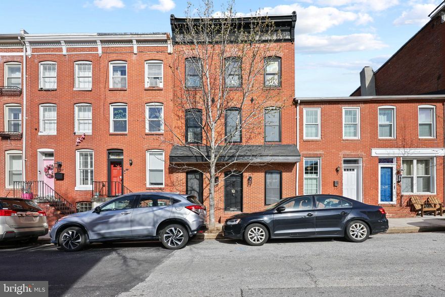 Welcome to one of the most unique and interesting homes that Federal Hill has to offer - 1241 William St. is roughly 3000 sq. feet of above grade living space and plenty of historical features! Arguably one of the best features of this home is the HUGE 2 CAR SIDE BY SIDE ATTACHED GARAGE w/ electric (garage has a newly replaced roof). Easily park any size vehicle and walk through the charming brick patio right into your house! Enjoy the private hot tub and room for a grill right off of the kitchen!  Additionally, the owners recently installed a brand new TREX deck above the garage, essentially a no-maintenance situation. Stepping inside this home you will be astounded at the true foyer complete with built-in closets that don’t eat into your living space plus enormous windows that let in so much natural light. The living and dining room space is massive, making any layout or furniture size work! Enjoy gorgeous exposed brick (a Baltimore staple) and all new flooring on the main level. The kitchen is very spacious with a brick fireplace. There are mock-up plans for a stunning kitchen reno as an example SEE PHOTOS*** (Kitchen Design By Idan). Heading upstairs you’ll be drooling over the original and refinished SOUTHERN PINE  FLOORING! The second level has 2 large bedrooms, a full bathroom plus a sitting room, additional built-in’s and deck access. The front room is just about the brightest room you could ever dream of with soaring ceilings! The “primary” suite is truly that, as it encompasses the entire footprint of the house. This upstairs suite features 2 walk-in closets, a huge bathroom with back closet with W/D hookup and stunning exposed wooden beams. The BEST part about this room is that under the carpet you’ll find THE SAME SOUTHERN PINE FLOORS as downstairs and tons of natural light…A DREAM! The possibilities are endless with that amount of space. Other note to mention: the basement is full and unfinished with 7 ft ceilings and a W/D plus workshop area (as mentioned, you can move a second W/D upstairs as there is a hookup).

Schedule your showing today as this one-of-a-kind home is ready to find its new owner!

Additional Updates include:

-          Central AC updated 2 years ago

-          New Thompson Creek windows on the first and second floor

-          New flooring main level

-          Refinished southern pine flooring upstairs

-          Freshly painted entire house

-          New Trex Deck

-          New screens in master bedroom

-          Hot Tub “guts” were replaced 3 years ago

-          Newly replaced roof on garage

Buyer to verify all ground rent information. Seller will not redeem.