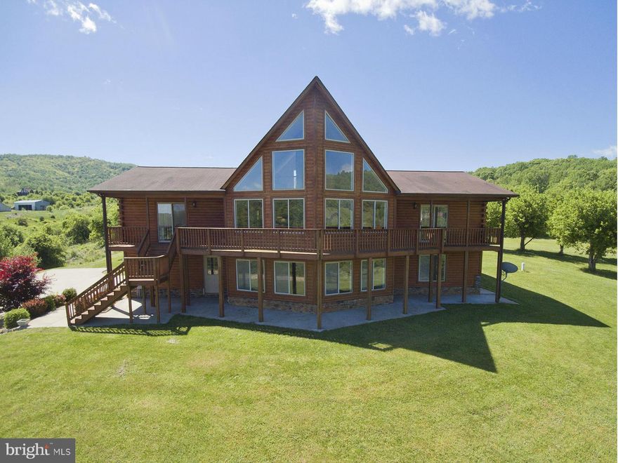 Gorgeous Log Chalet on 10 Acres w/Views In Every Direction!  Beautiful Setting Includes Stocked Pond, Stream, Apple Trees, 20 Ft. Stone Fireplace in Great Room.  Home Features Stainless Steel Appliances, Granite Countertops, Hardwood Floors, Main Level Luxury Master Bath w/Whirlpool Tub & Sep Shower.  Upper Level Loft.  Finished Lower Level to Include Rec Room, Study, & Bedroom.  Minutes to I66.